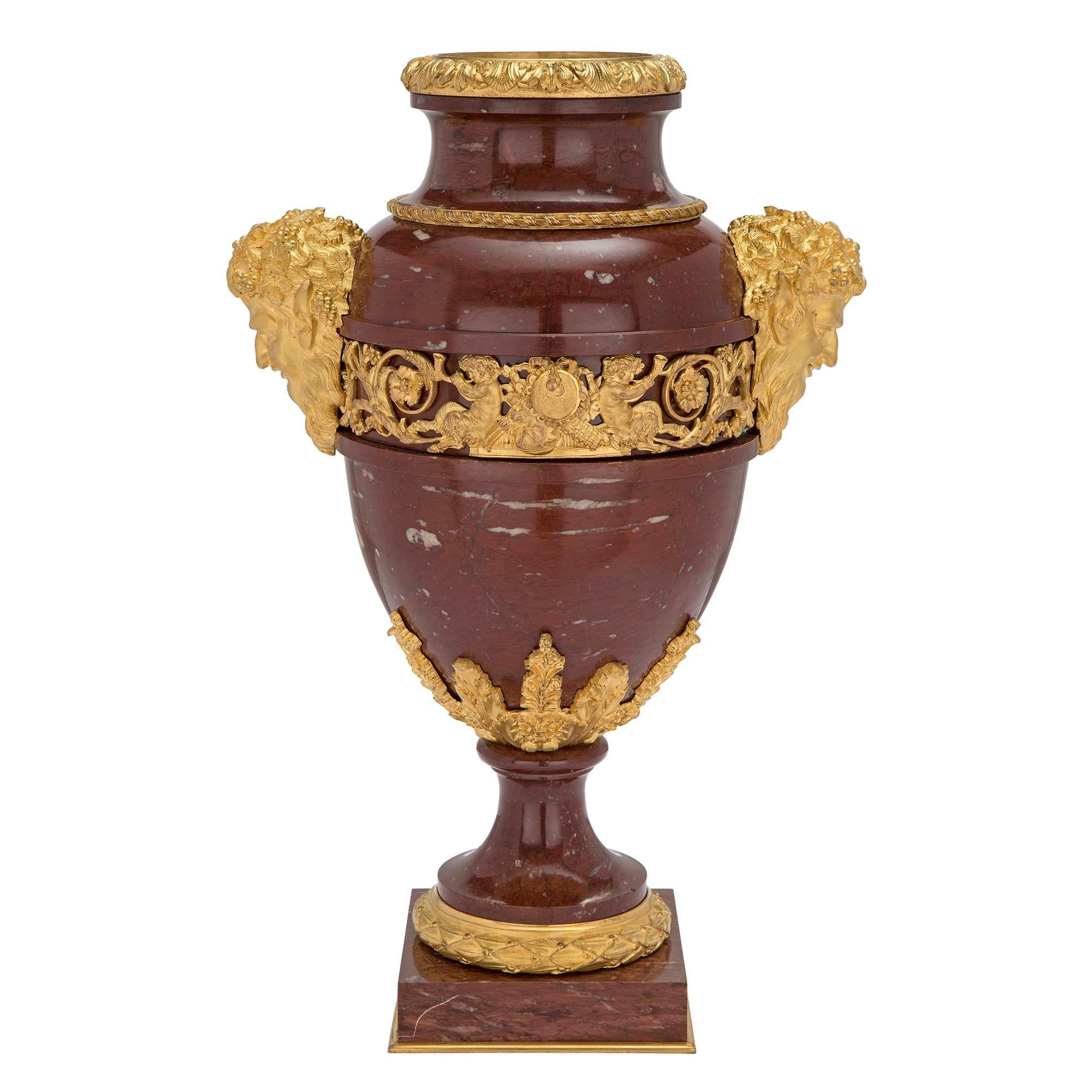 A high quality French 19th century Louis XVI st. Rouge Grotto marble and ormolu vase. The urn is raised by a square base with a decorative ormolu band below a fine berried laurel ormolu band and marble socle pedestals. The body displays rich foliate