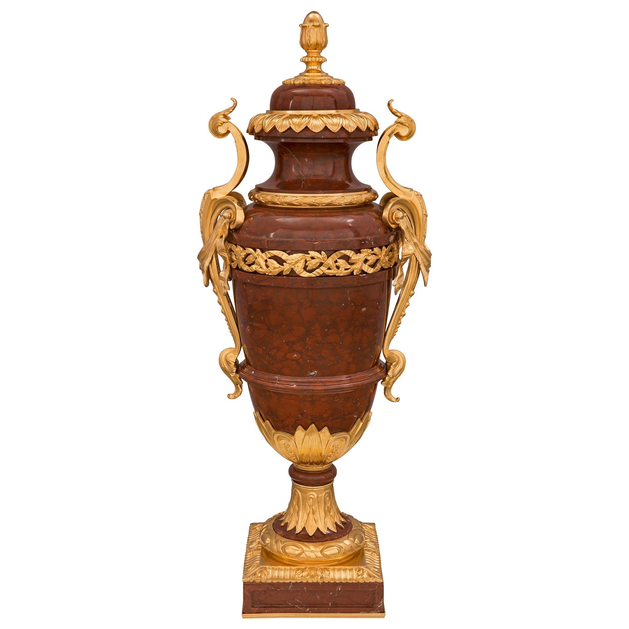 A stunning and very high quality French 19th century Louis XVI st. Rouge Griotte marble and ormolu lidded urn. The urn is raised by a square base with a most decorative recessed plaque at each side, a fine bottom ormolu fillet, and a striking fluted