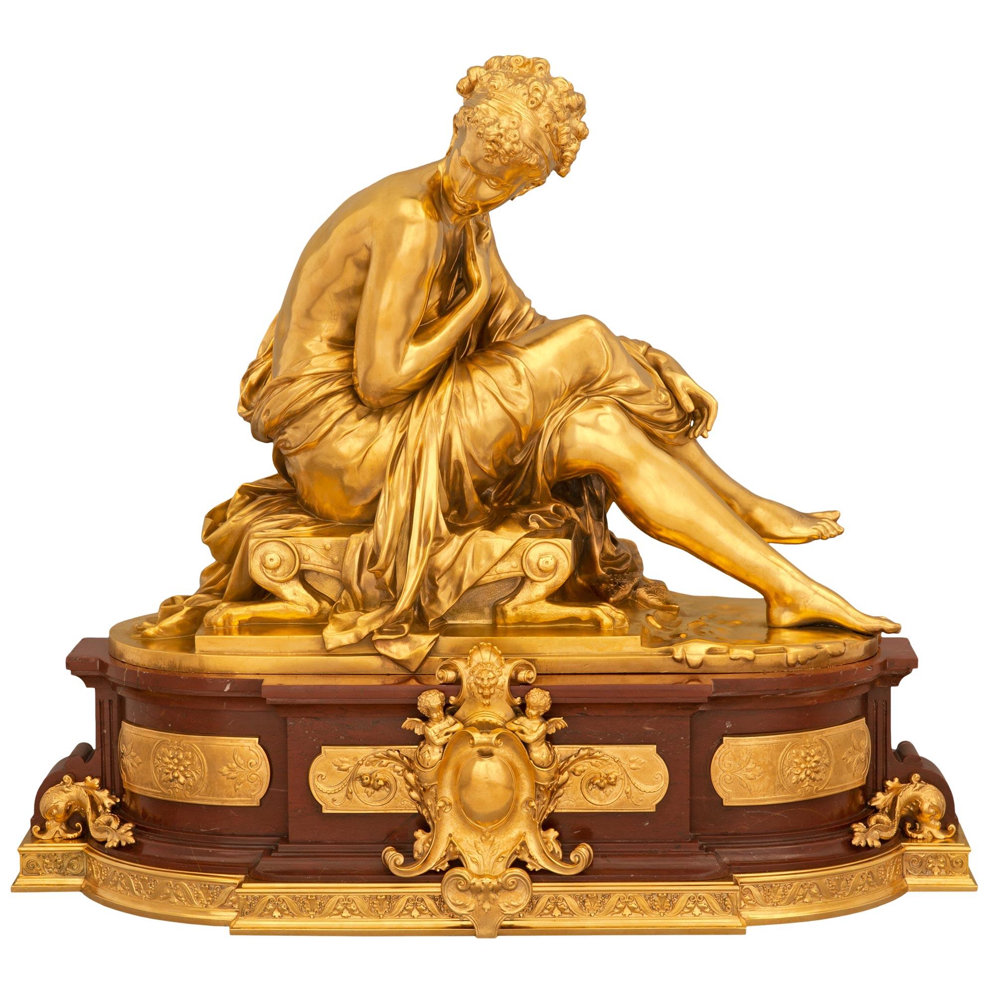 A stunning and very high quality French 19th century Louis XVI st. Rouge Griotte marble and ormolu statue signed Moreau. The statue is raised on its original most impressive oblong shaped Rouge Griotte marble base with an exquisite bottom mottled