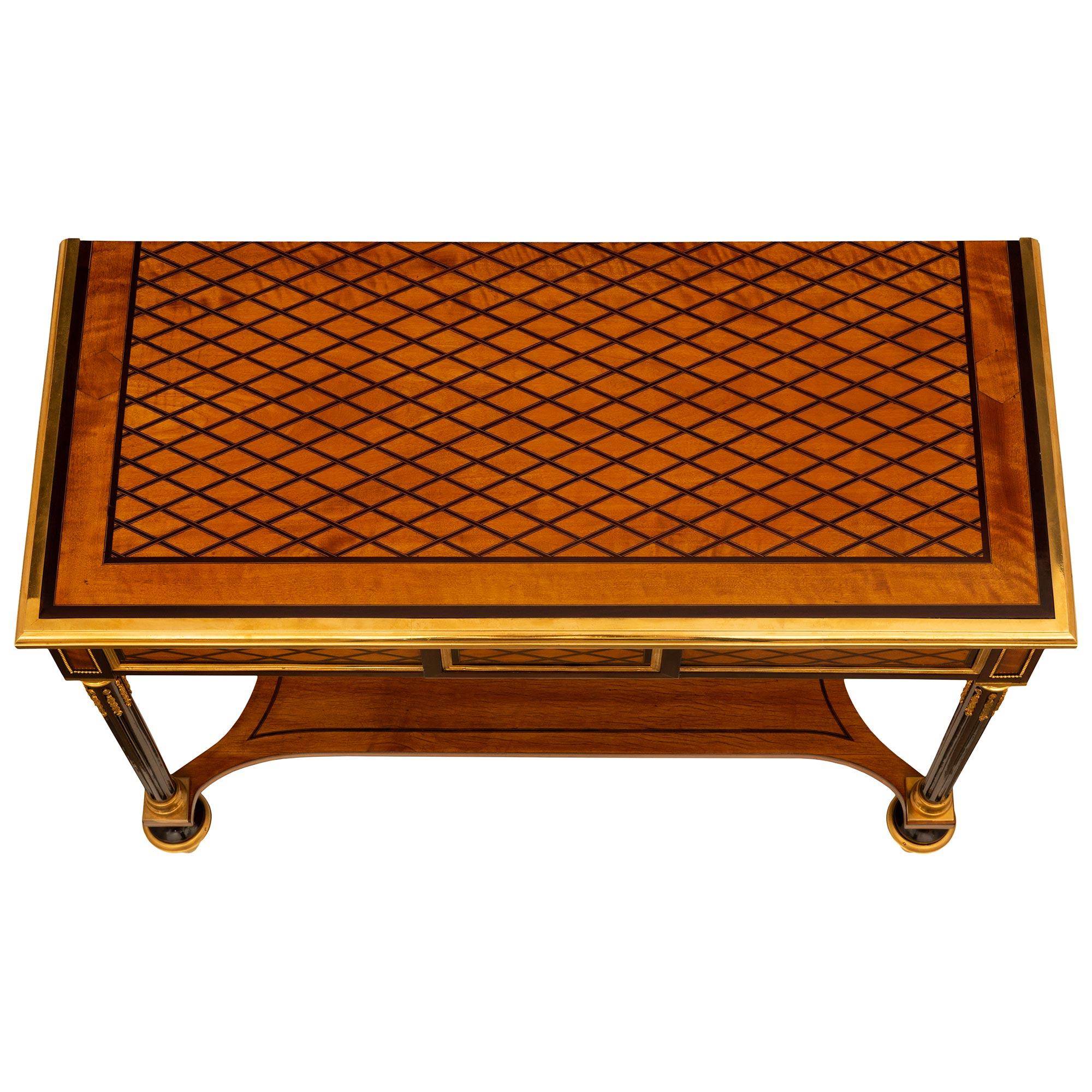 A stunning French 19th century Louis XVI st. Satinwood, Mahogany and Ormolu console. The beautiful freestanding console is raised on elegant topie shaped Mahogany feet with circular Ormolu sabots. Each leg is connected by a wonderful Satinwood