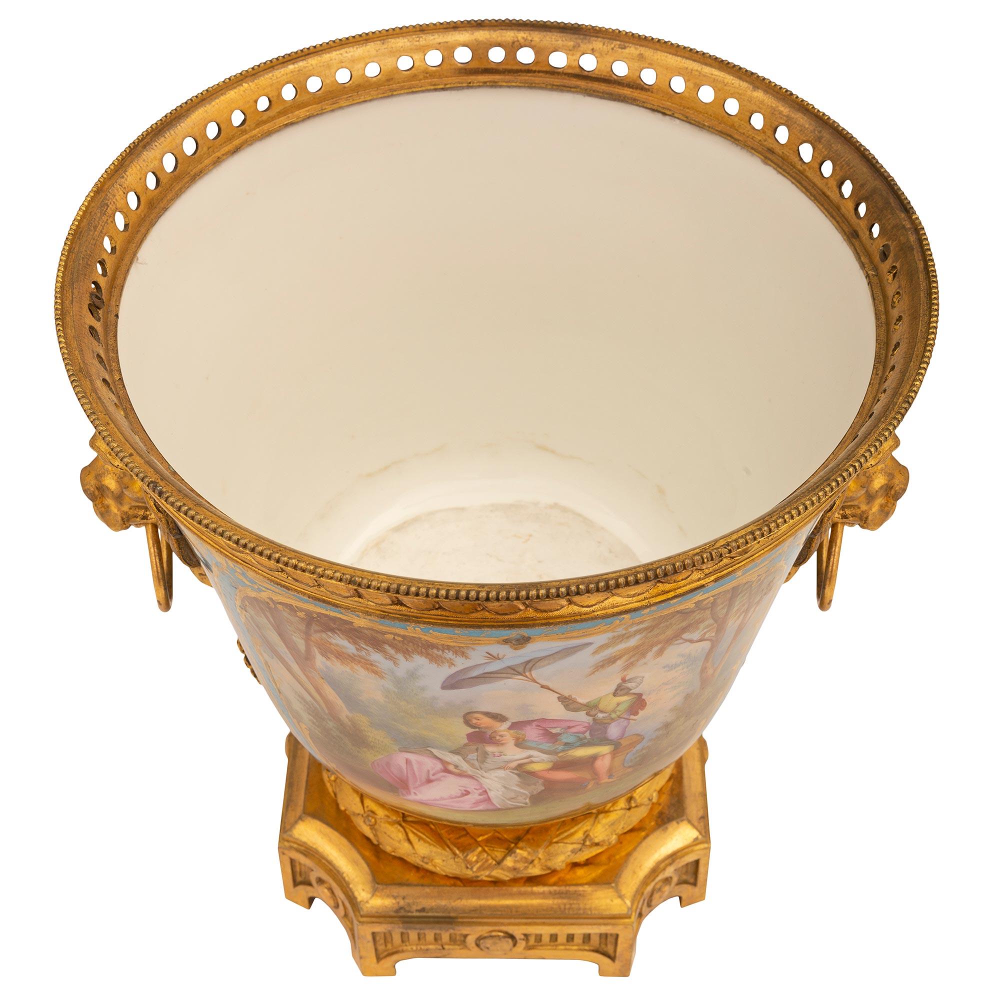 A charming and very high quality French 19th century Louis XVI st. Sèvres porcelain and ormolu vase/centerpiece. The centerpiece is raised by an elegant square base with concave corners, a lovely fluted design with recessed panels, a mottled border,