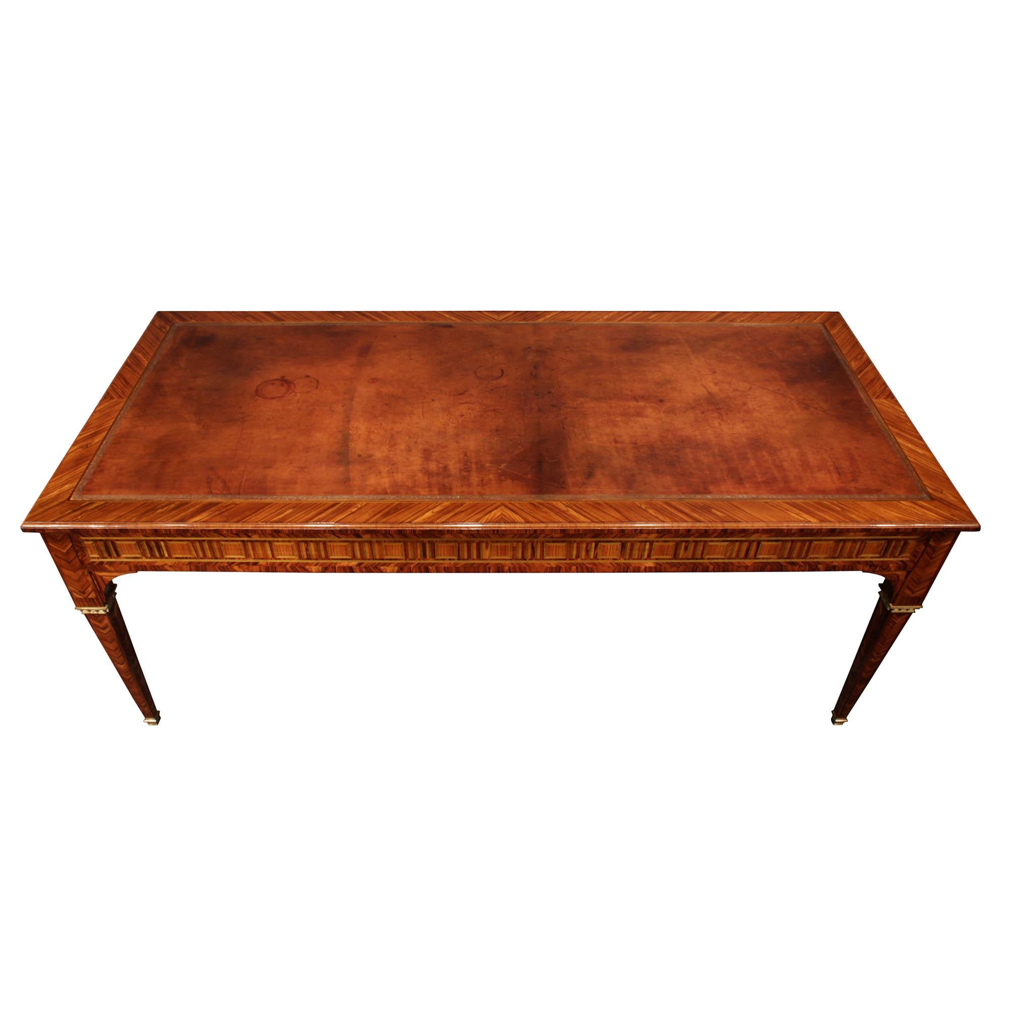 A superb French mid 19th century Louis XVI st. herringbone design tulipwood center table. The table is raised on elegantly tapered legs with ormolu sabots and dentil top crown. The apron is decorated with a geometric charmwood inlay, at each side.