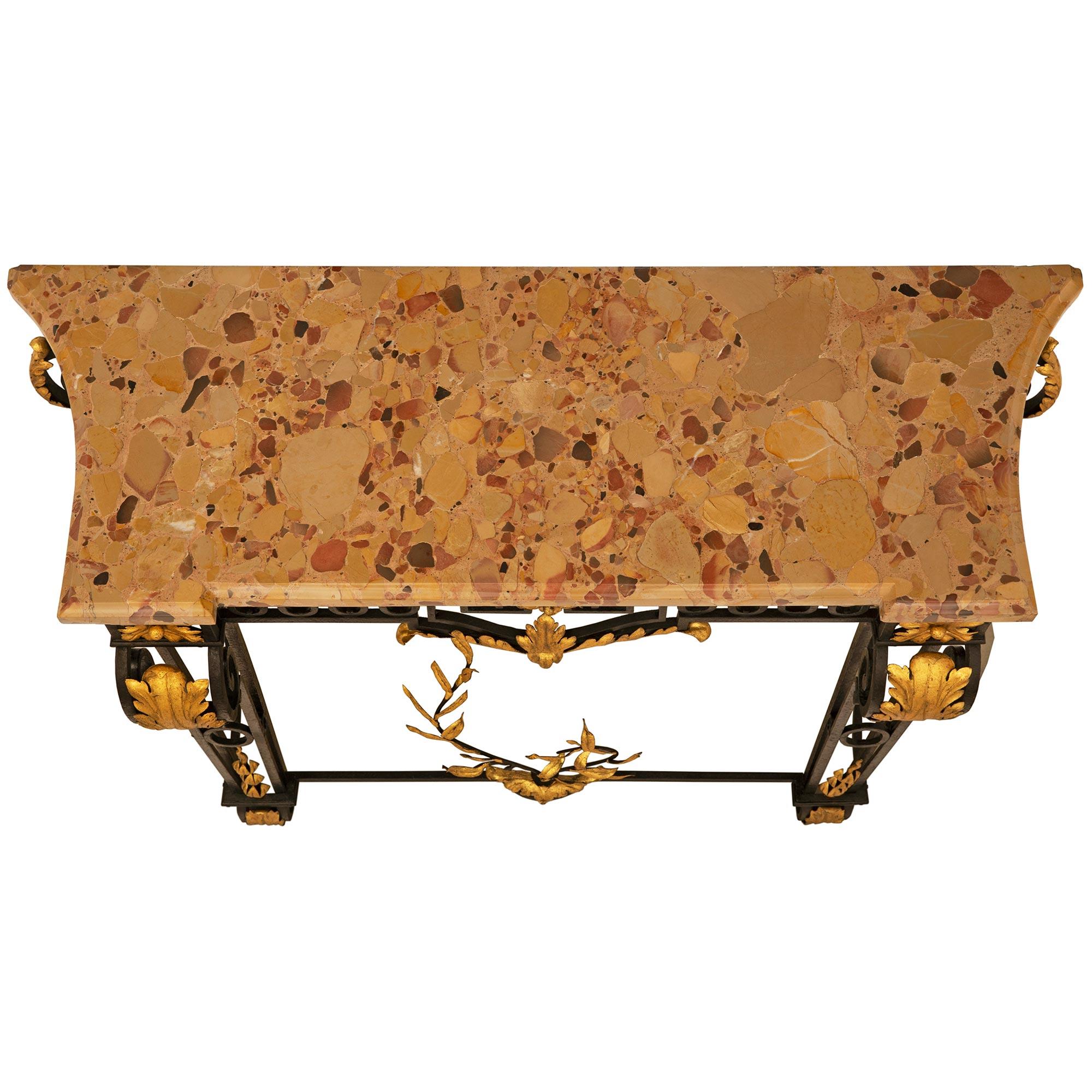 A stunning French 19th century Louis XVI st. Wrought Iron, Gilt Metal and Brèche d'Alep marble console. This freestanding console is raised by four elegant pierced scrolled Wrought Iron supports with scrolled Wrought Iron feet and overlapping Gilt