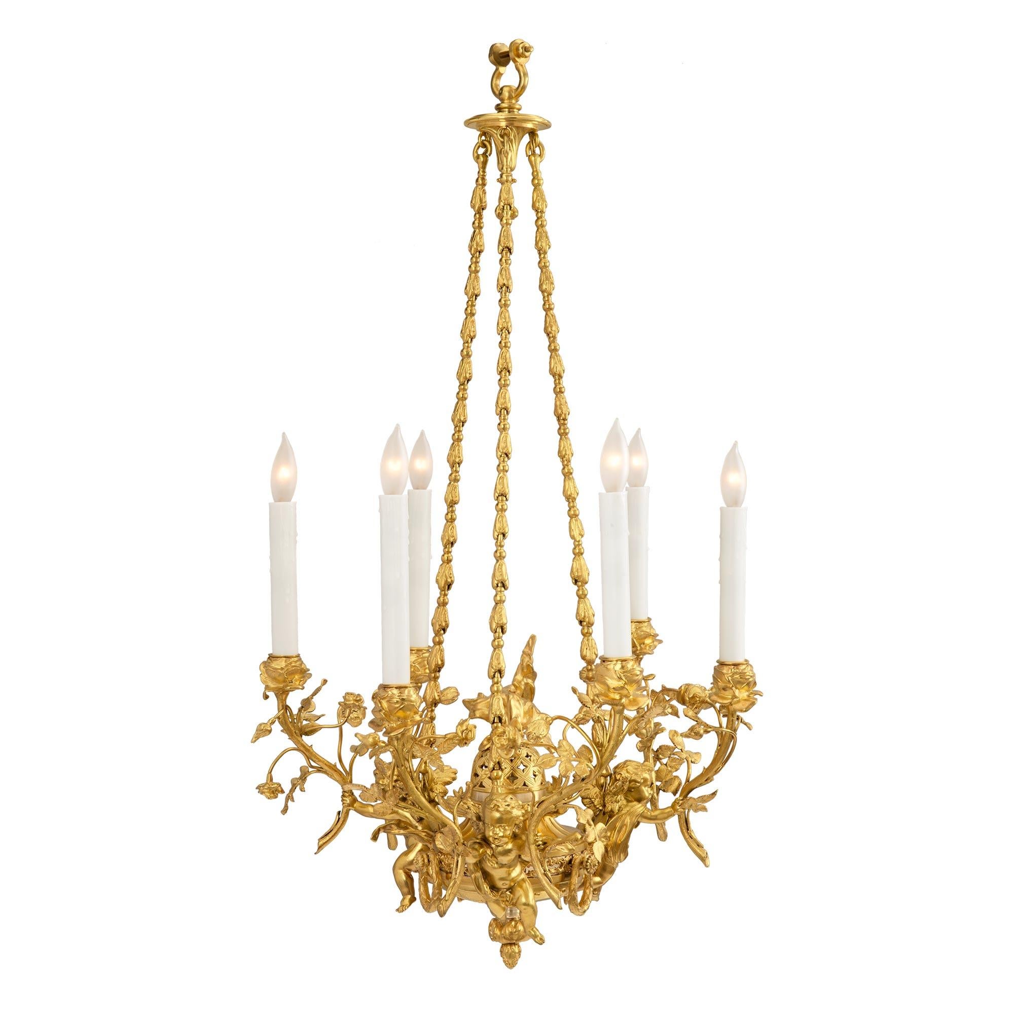 A beautiful and extremely high quality French 19th century Louis XVI st. Belle Époque period six arm ormolu chandelier, attributed to Henry Dasson. The chandelier displays a lovely inverted bottom foliate finial centered by four fine foliate
