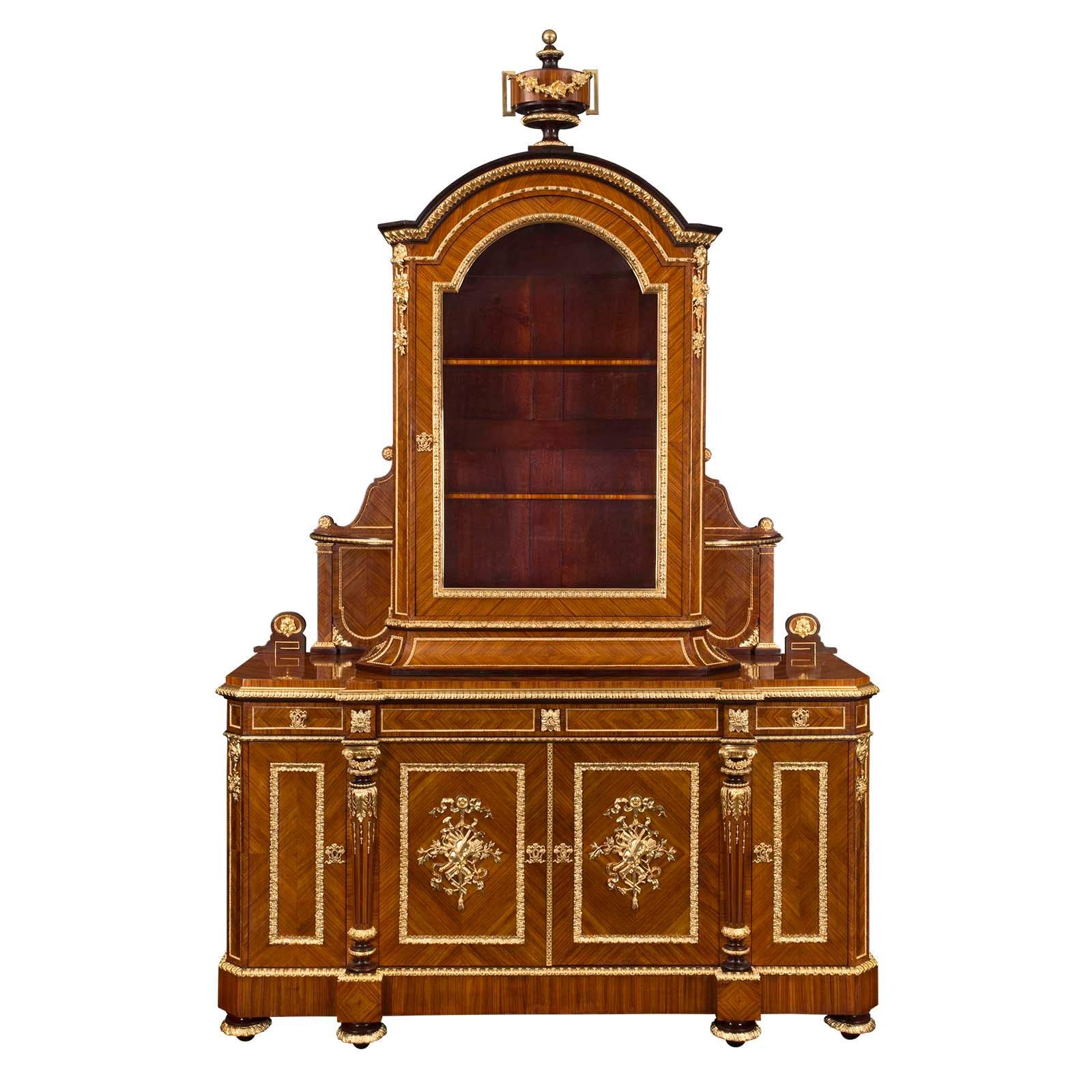 A stunning and extremely high quality French 19th century Louis XVI st. Belle Époque Period Tulipwood and ormolu cabinet by Grohé, à Paris. The cabinet is raised by six elegant topie shaped feet with foliate ormolu bands. Above the decorative ormolu