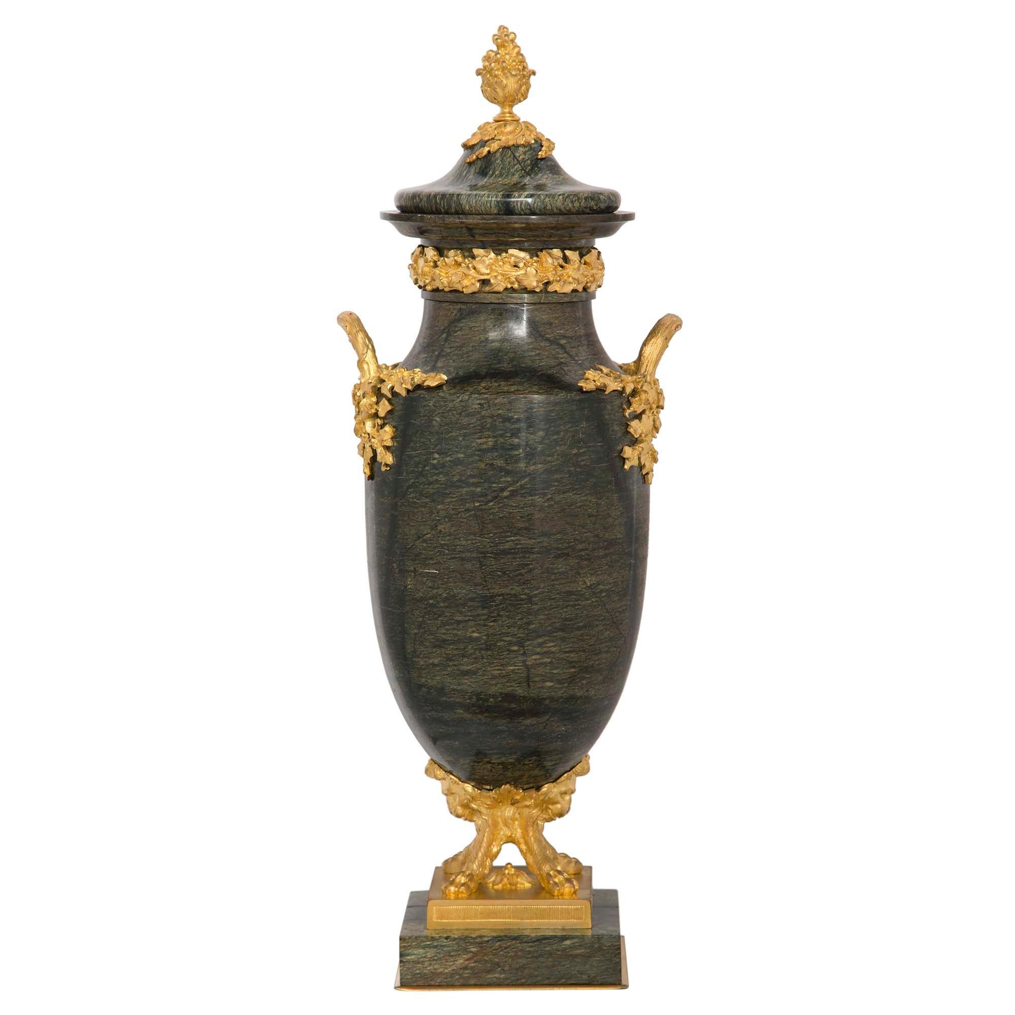 A most elegant and uniquely shaped French 19th-century Louis XVI st. Brèche Verte d'Egypte marble and ormolu urns. Each urn is raised by a square marble base below an ormolu support with a fitted reeded band and richly chased paw feet and lion