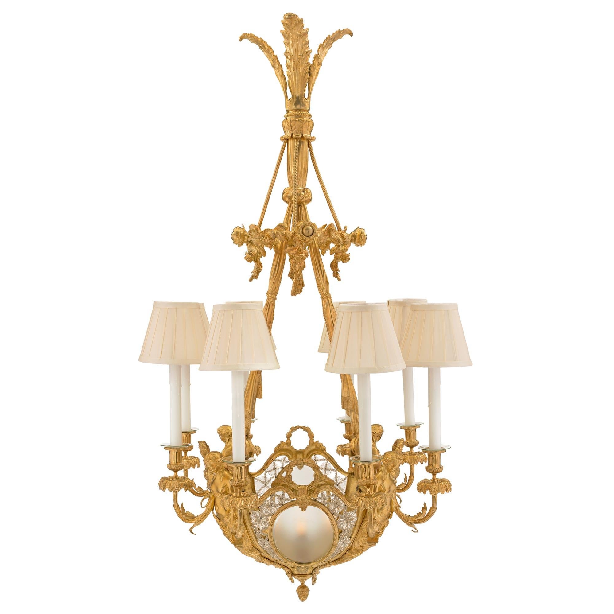 A most elegant and high quality French 19th century Louis XVI st. ormolu, frosted and cut glass, twelve light chandelier , in the manner of Henri Dasson. The chandelier with the a bottom acorn finial has four 'C' scrolled maidens flanking central