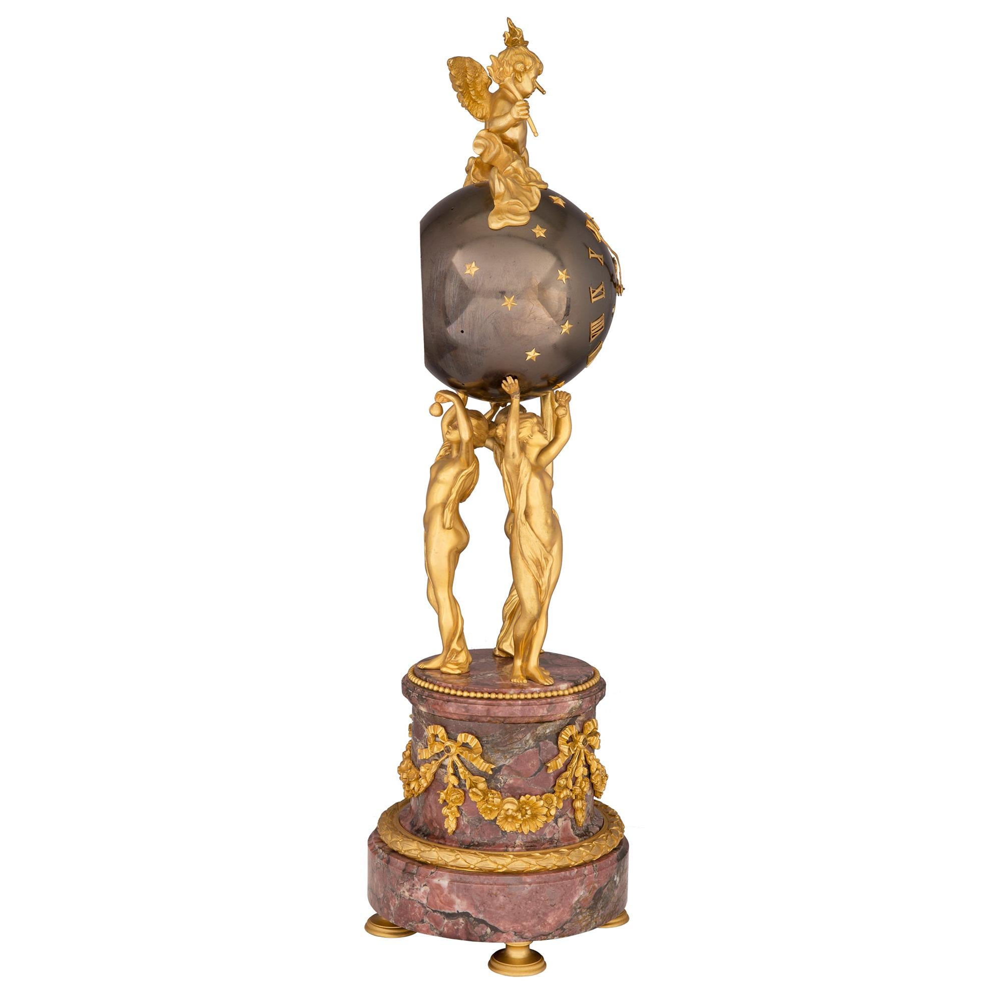 A stunning and most unique French 19th century Louis XVI st. ormolu, patinated bronze and marble clock, stamped Vincent 1855. The clock is raised by fine ormolu supports below the circular marble base decorated with a charming wrap around berried
