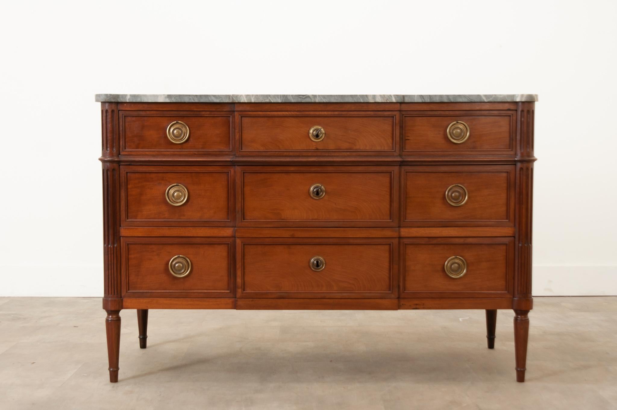 This fantastic Parisian walnut commode was crafted in 19th century France circa 1850.  The original break front marble top with turret edges is shaped according to the body of the piece. Three top drawers open separately, while the two bottom