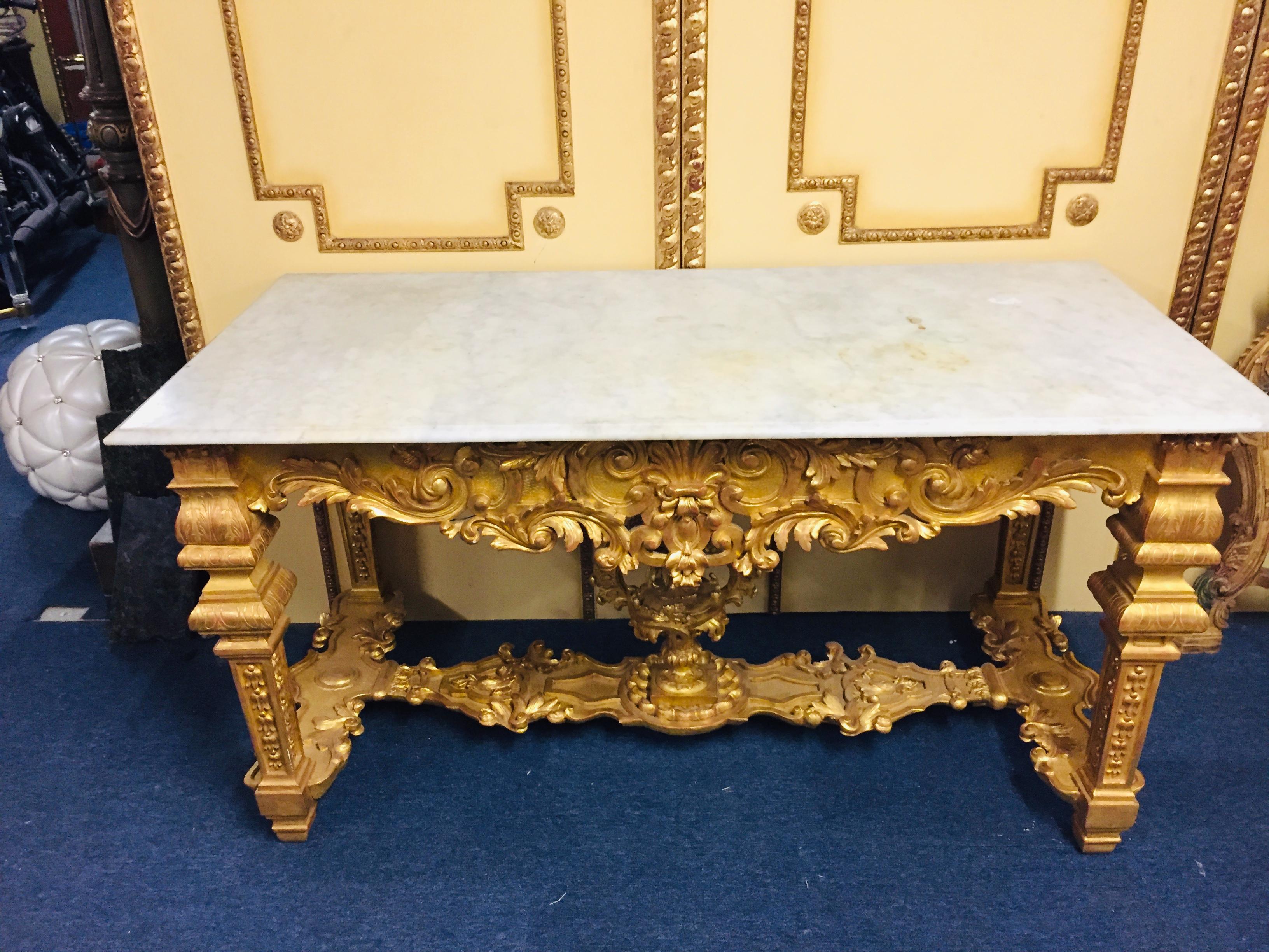 A stunning Louis XVI style gilded wood console table with nicely-carved neoclassical details, including wreath and tapered fluted legs, circa 1900. Console table has a White Marble top 
An extremely elegant French 19th century Louis XVI st.