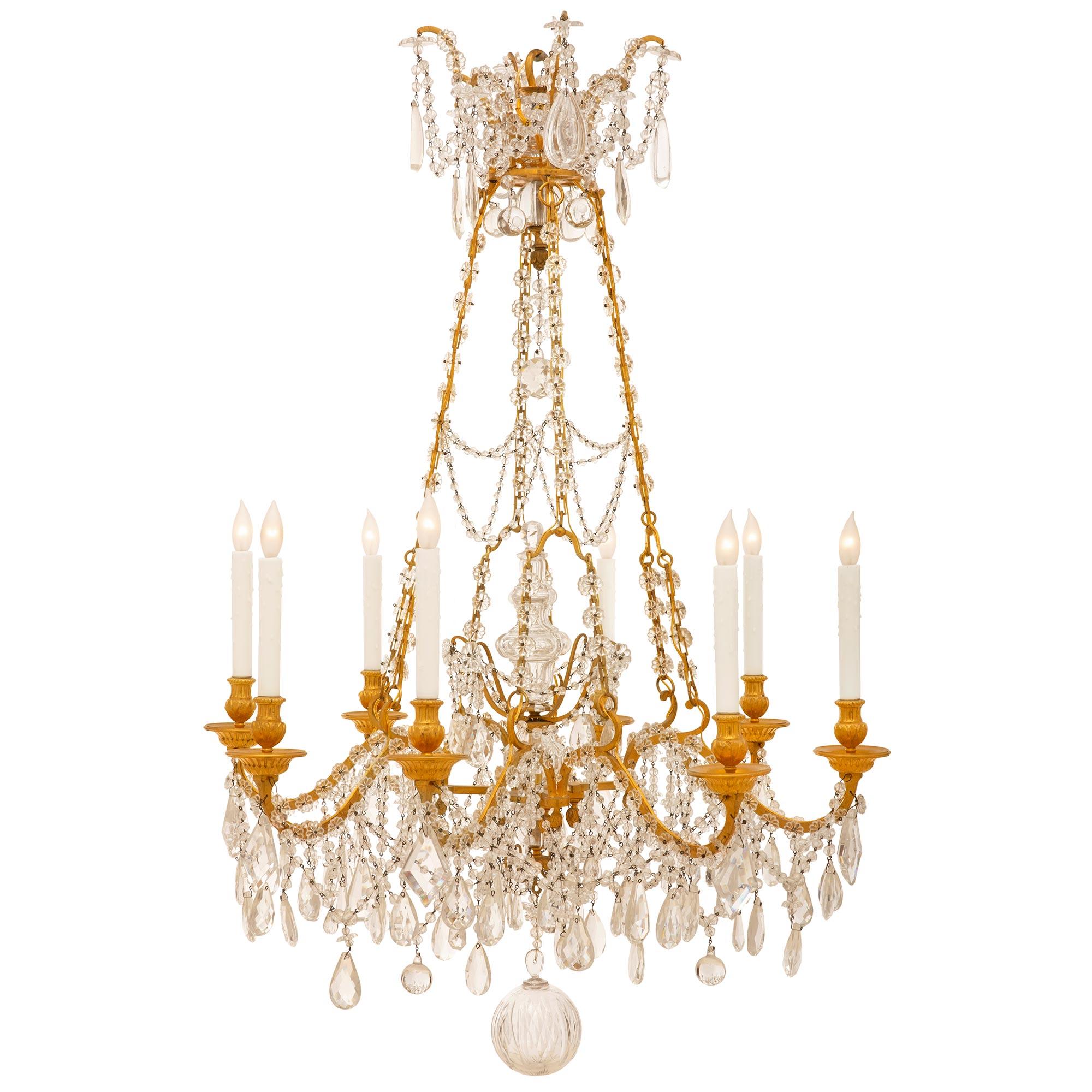 An outstanding and high quality mid 19th century French Louis XVI st. ormolu and Baccarat crystal eight light chandelier. The eight 'S' scrolled arms are heavily decorated by exquisite kite and water drop shaped crystals topped by rosettes and