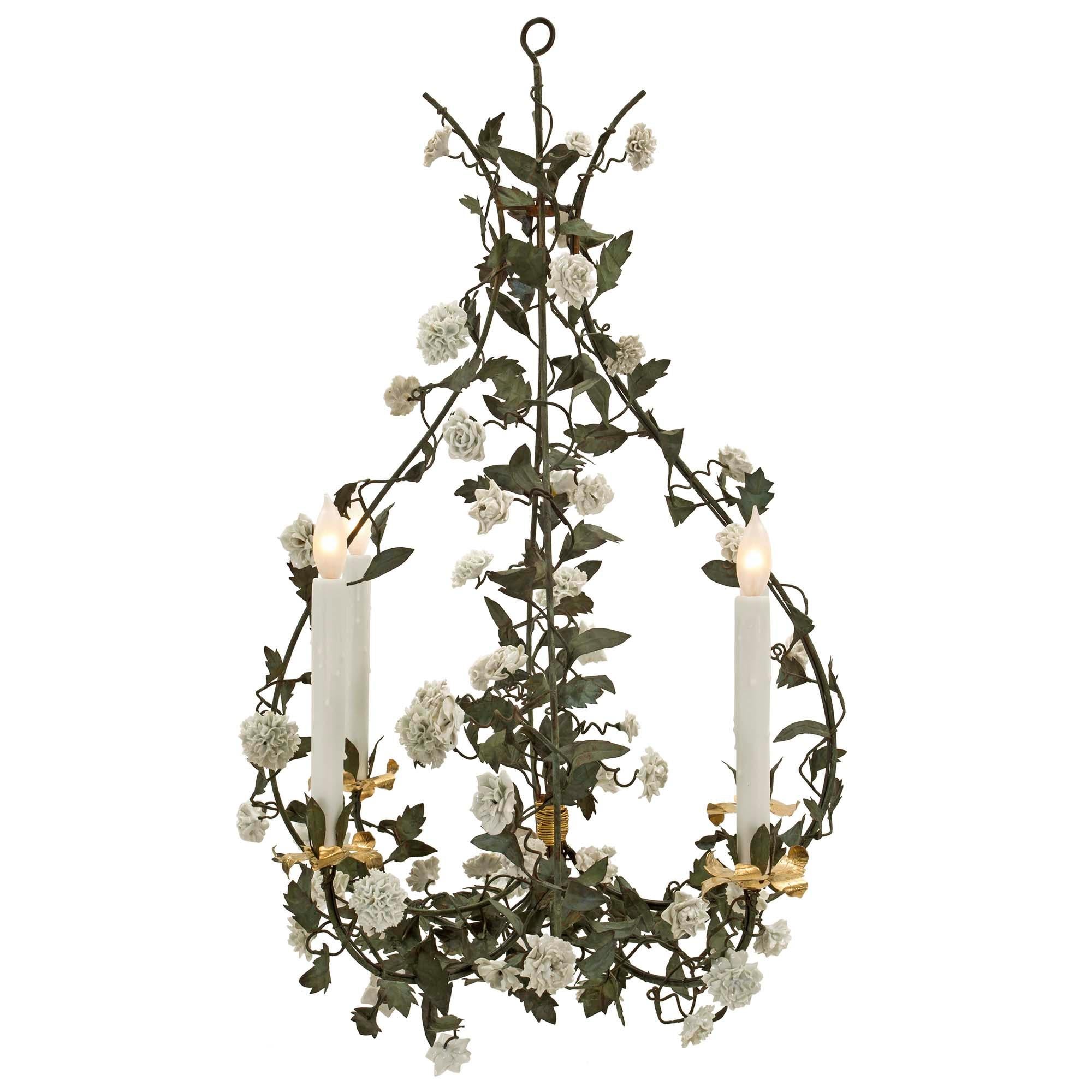 A charming French 19th century Louis XVI st. Saxe porcelain, tole and gilt metal four arm chandelier. The chandelier displays a most elegant shape with four lightly scrolled support leading up the cage and tied with a unique and most decorative gilt
