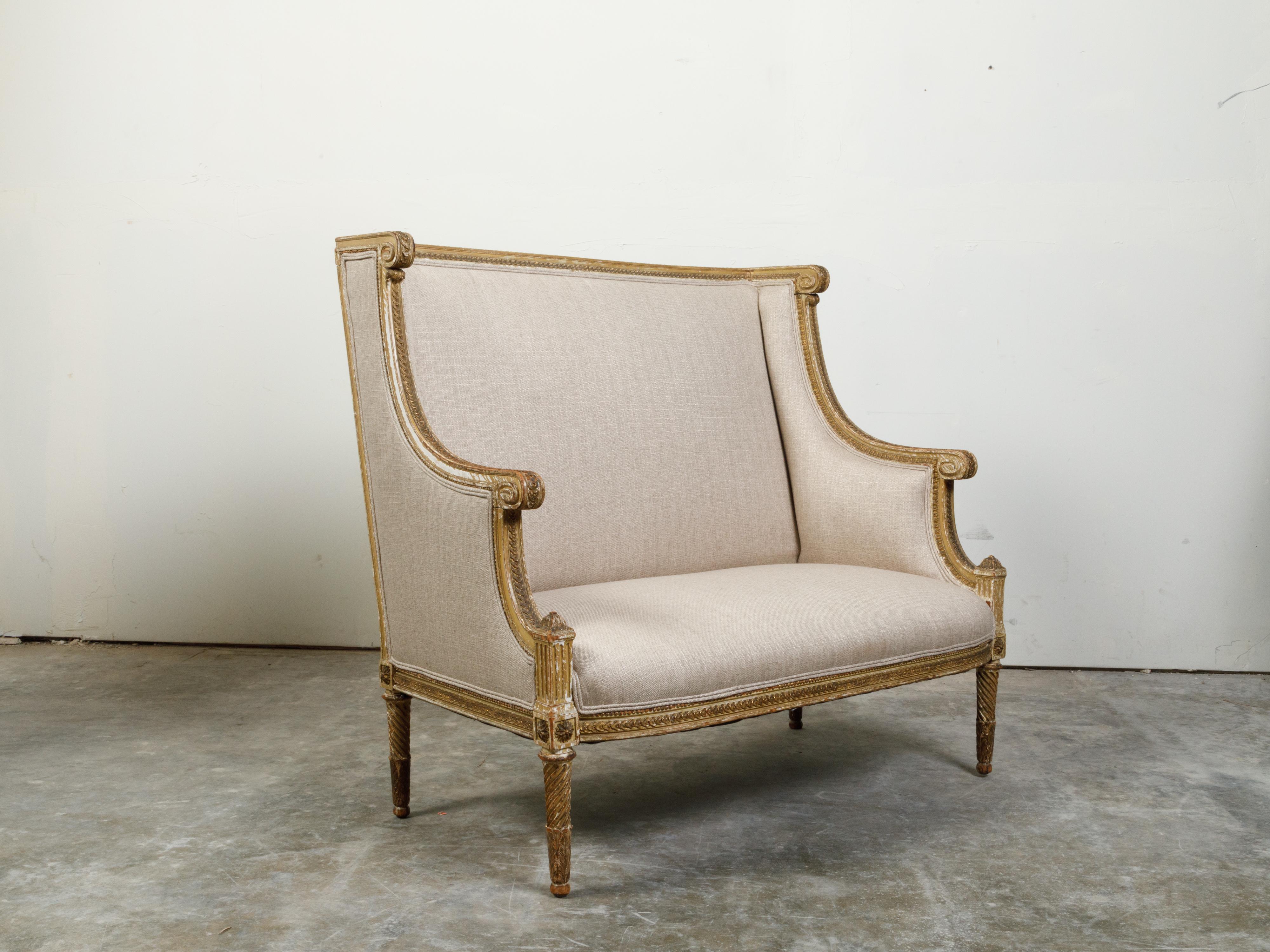French 19th Century Louis XVI Style Giltwood Wingback Settee with Carved Motifs In Good Condition For Sale In Atlanta, GA