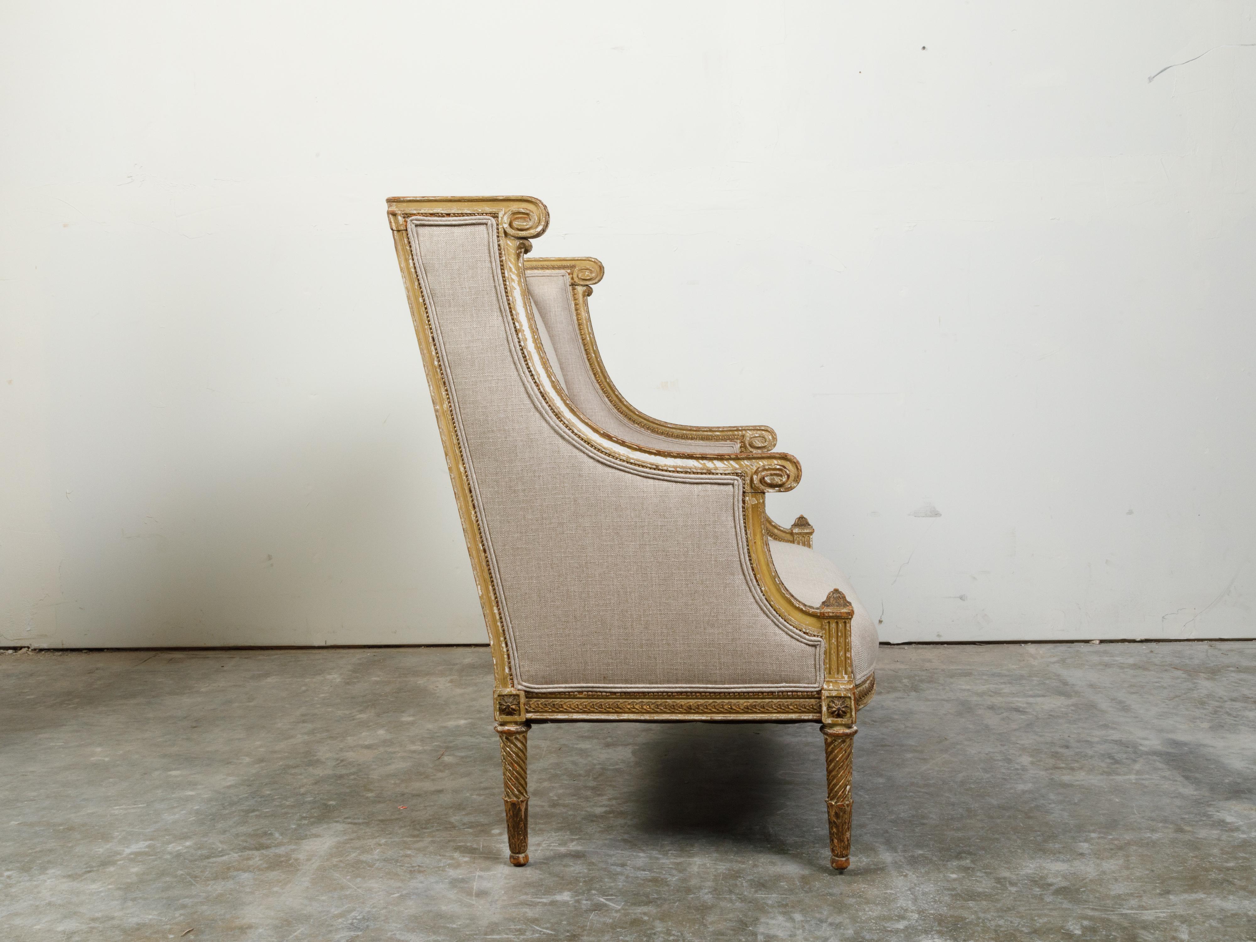 Upholstery French 19th Century Louis XVI Style Giltwood Wingback Settee with Carved Motifs For Sale