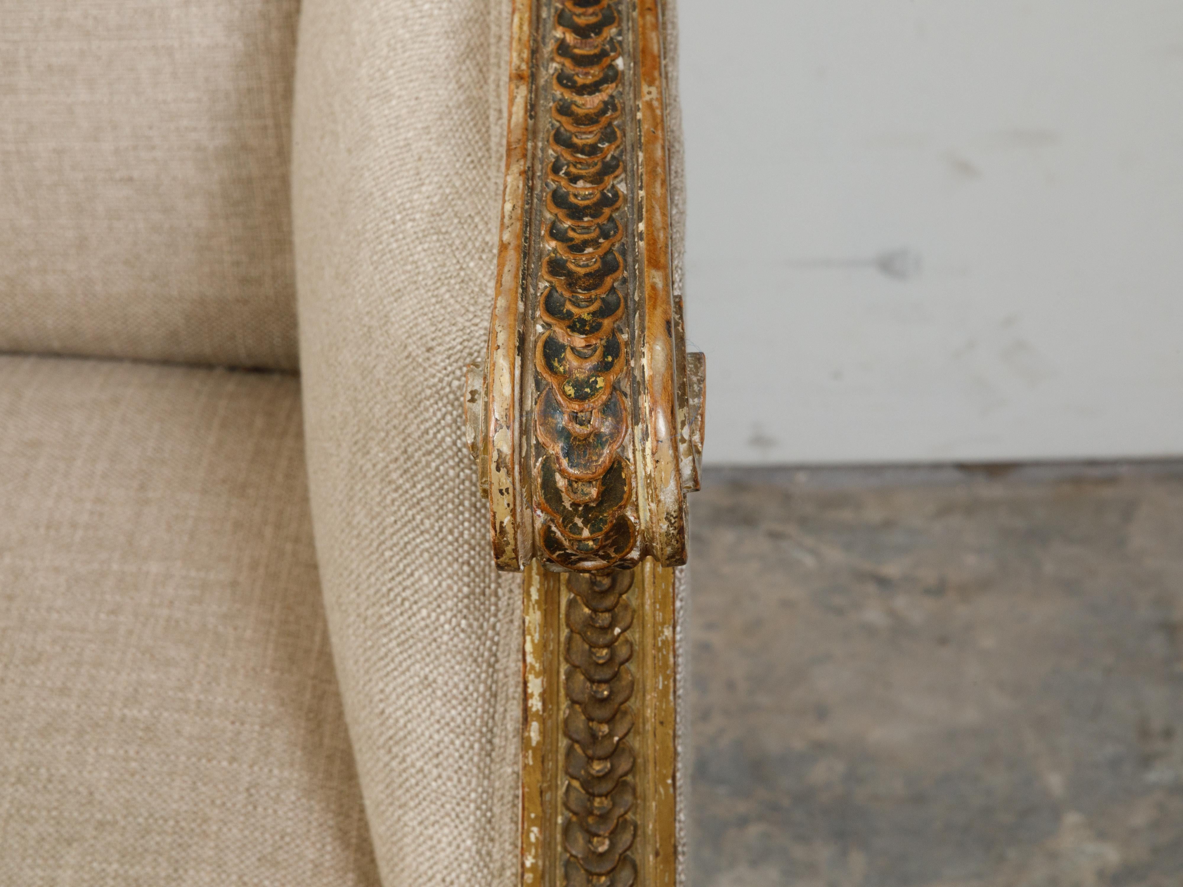 French 19th Century Louis XVI Style Giltwood Wingback Settee with Carved Motifs For Sale 4