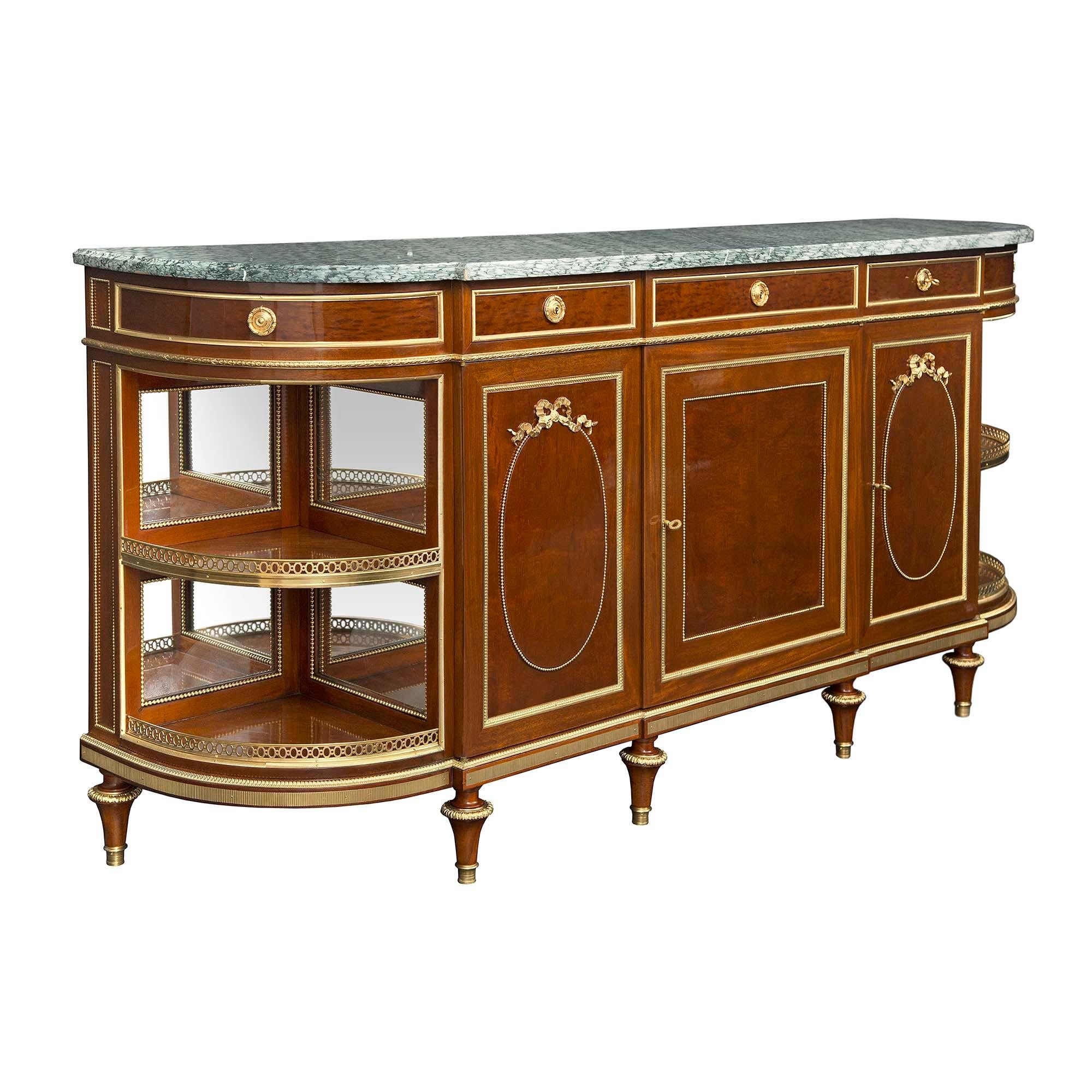 A high quality and most elegant French 19th century Louis XVI st. mahogany and ormolu buffet. The three drawer and five drawer buffet is raised by circular tapered legs with ormolu feet and fine ormolu top caps below a fluted ormolu frieze. Each