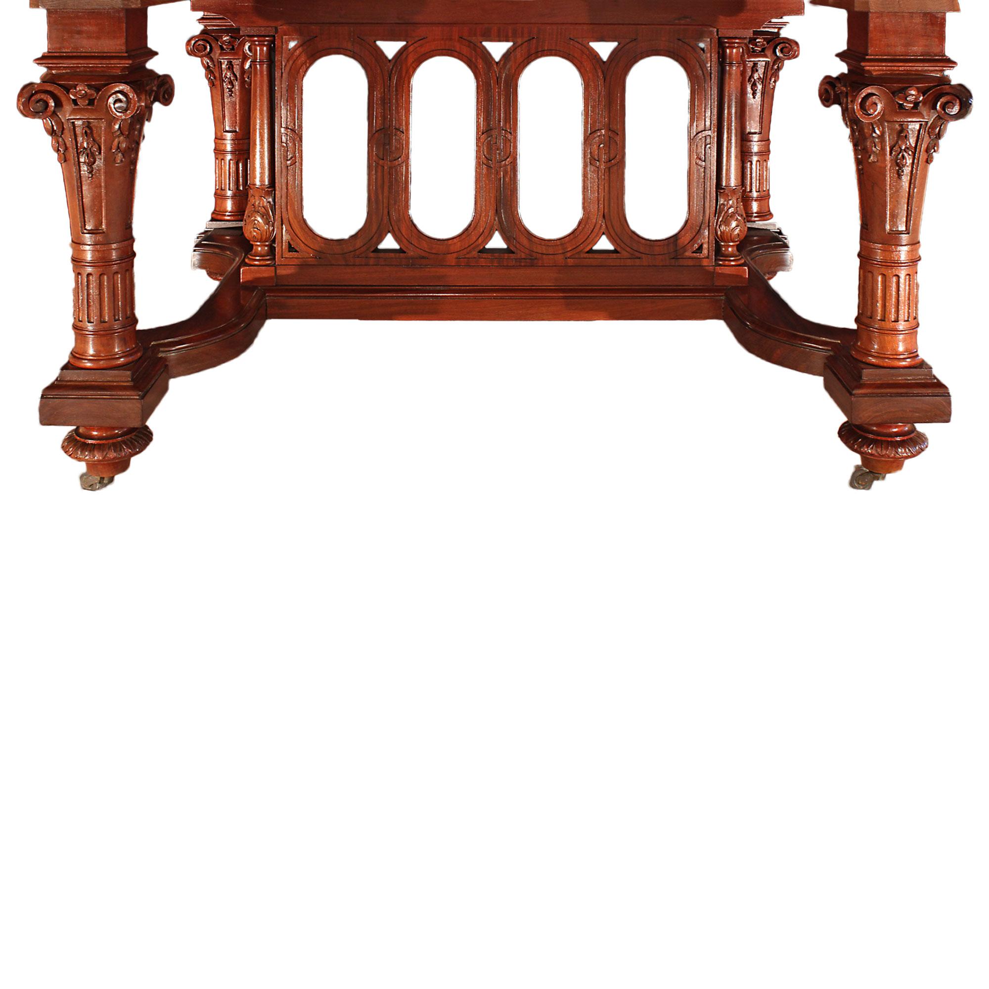 A handsome French 19th century Louis XVI st. solid mahogany dining table with the original four extensions. The table has a richly carved central pedestal with four fluted tapered columns raised by topie shaped supports. The columns are decorated by