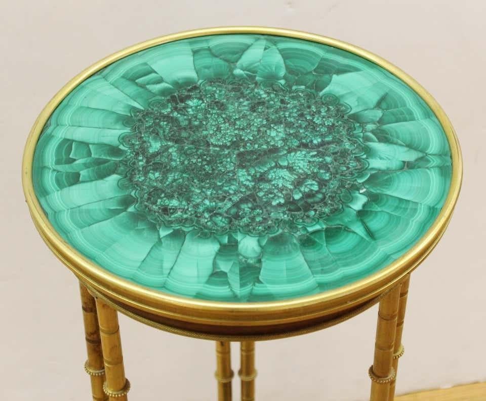 French Louis XVI style malachite gueridon table with ormolu mounts, the circular top tier supported on cluster legs of bamboo shape, the columns joined by a concave-shaped lower tier with Malachite elements, in the manner of Adam Weisweiler, circa