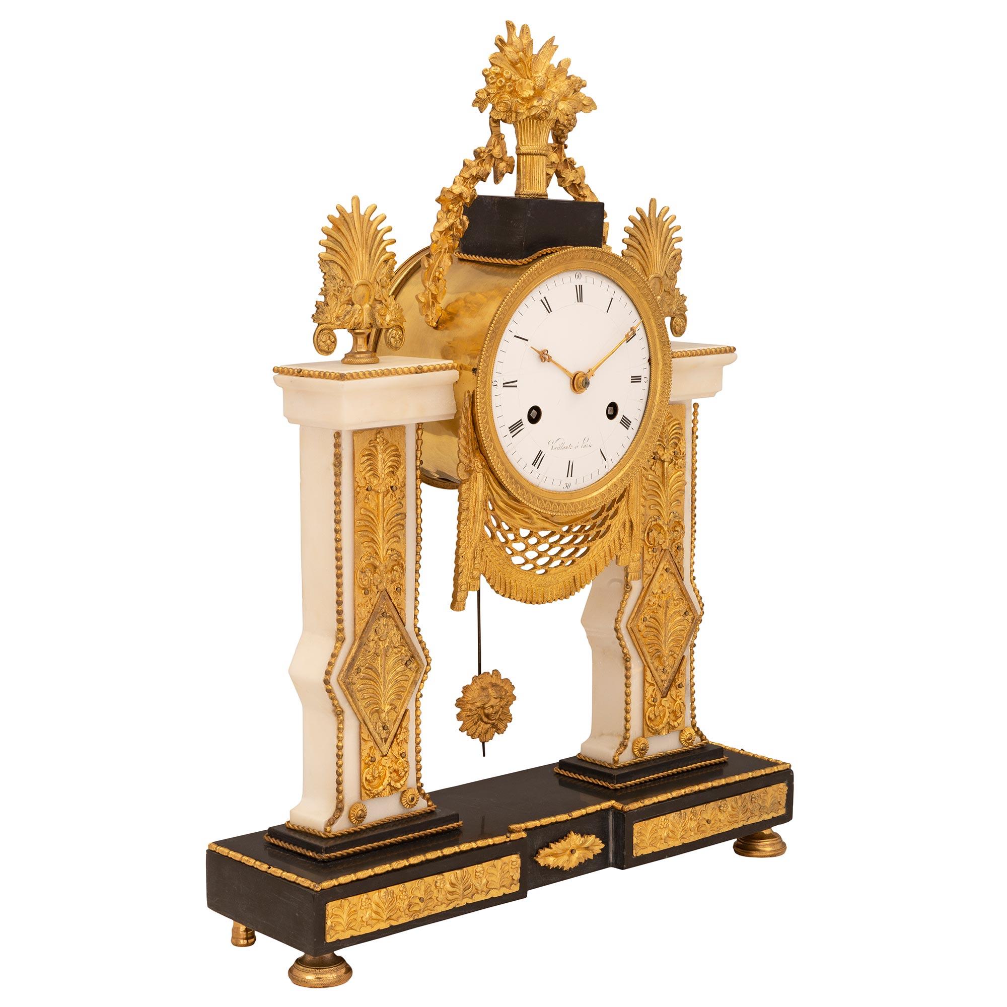 A striking French 19th century Neo-Classical st. ormolu, black Belgian and white Carrara marble clock, signed Vaillant à Paris. The clock is raised by a black Belgian marble base with fine ormolu topie feet and striking fitted ormolu plaques with