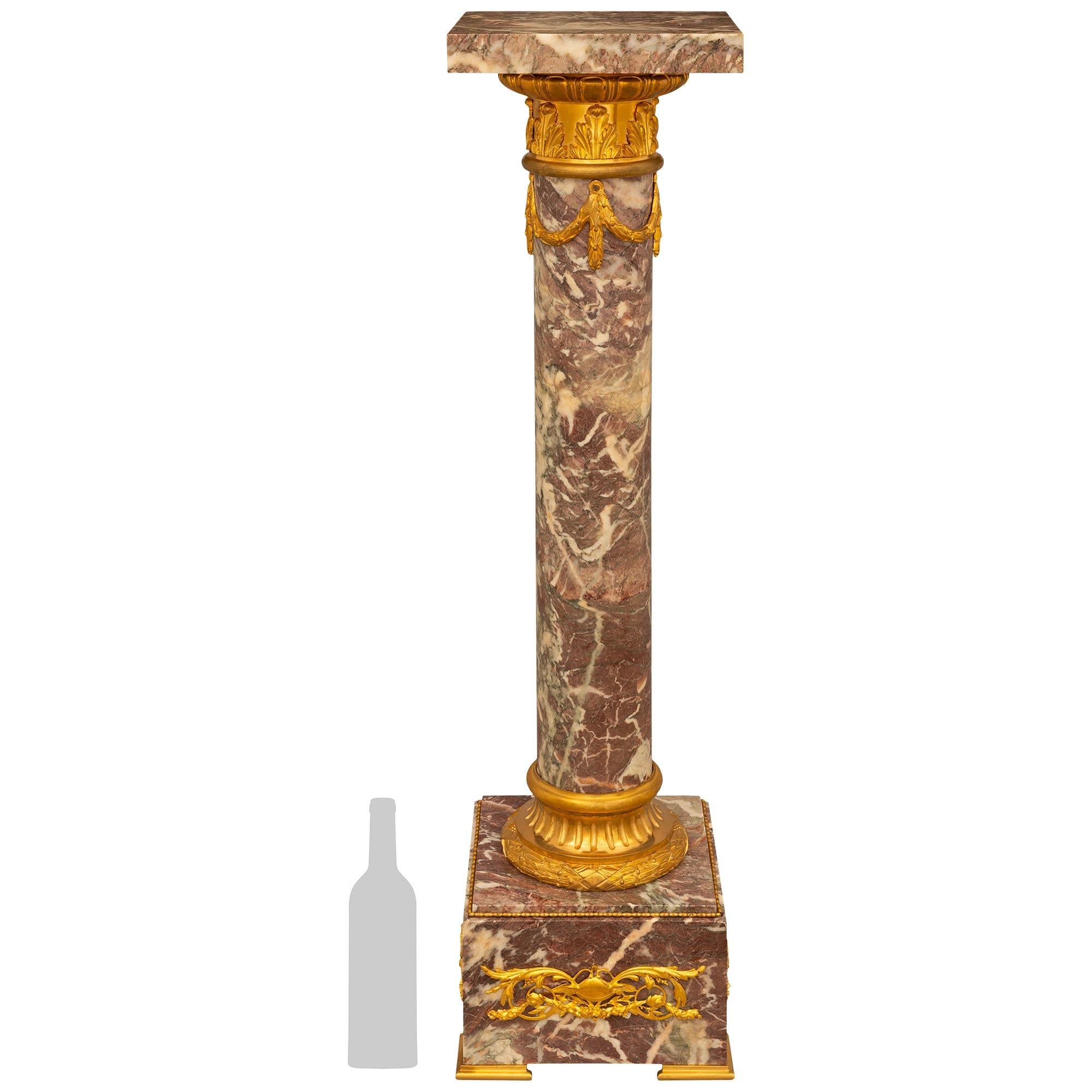 An extremely high quality French 19th century Louis XVI st. Fleur de Pêcher marble and Ormolu pedestal. This exquisitely decorative pedestal is raised on a square marble base with Ormolu feet and beaded borders, above and below pierced Ormolu mounts
