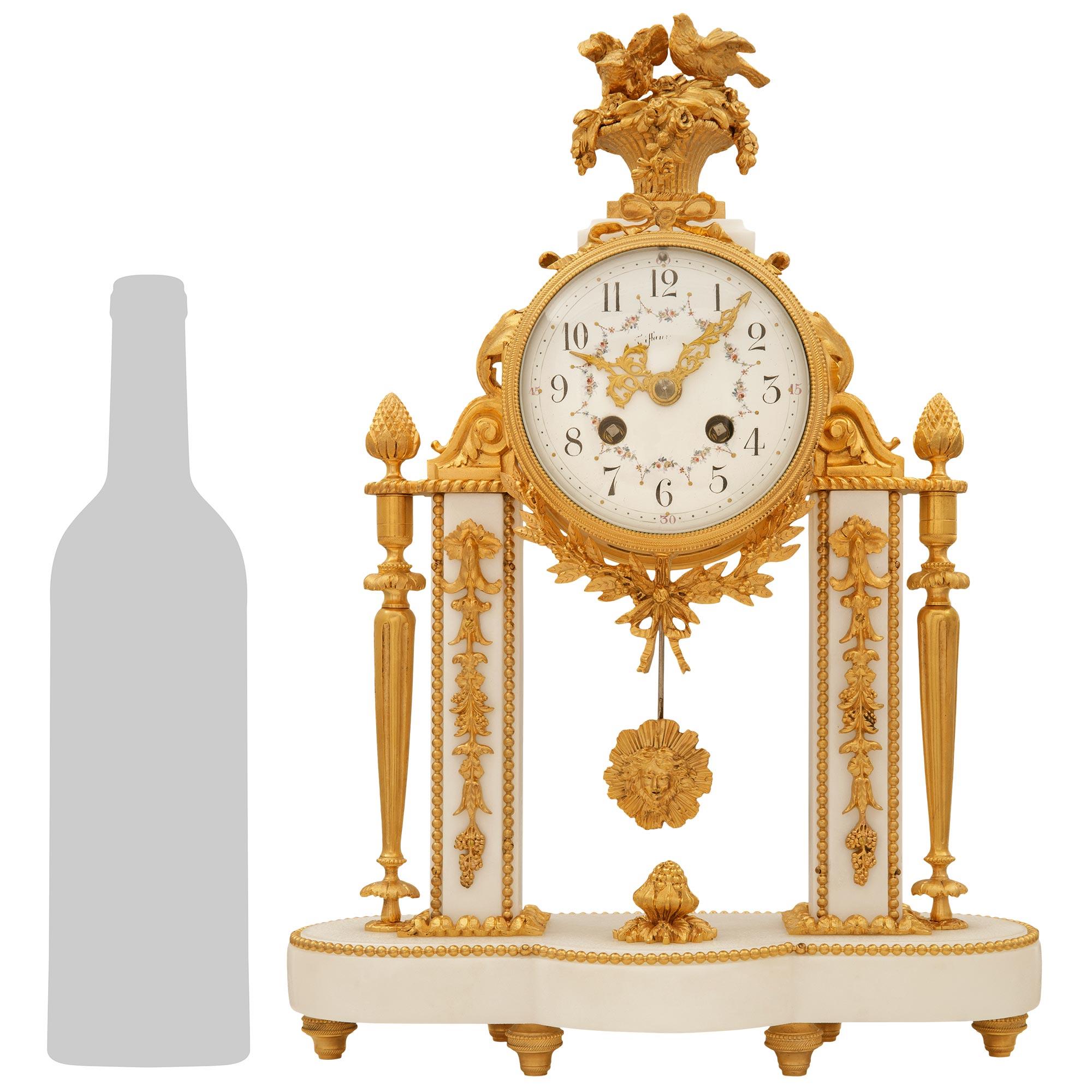 An exquisite and high quality French 19th century Louis XVI st. white Carrara marble and ormolu Portique clock, signed 