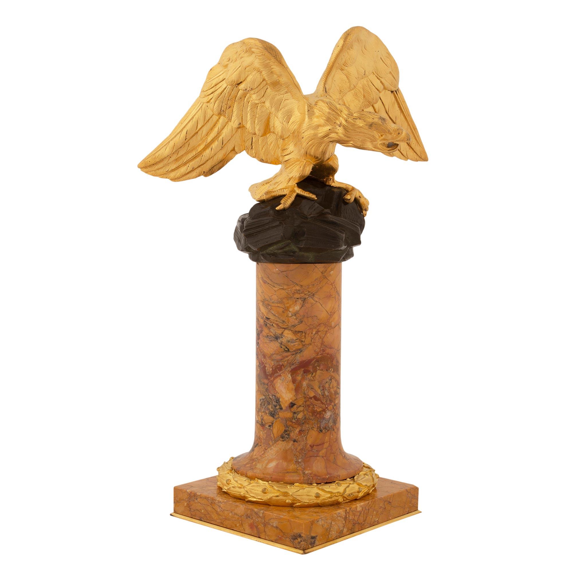 A unique and extremely decorative French 19th century Louis XVI st. Sienna marble, patinated bronze and ormolu statue. The small scale statuette is raised by a square base with a fine wrap around berried laurel band and a circle pedestal support.