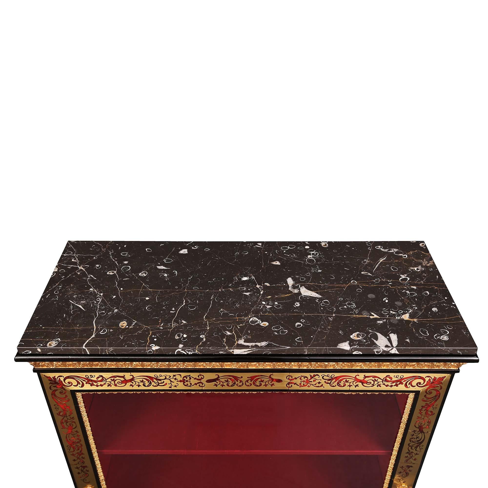 A superb French 19th century Louis XVI style Napoleon III Period Boulle cabinet vitrine. The ebony cabinet is raised on a scroll carved base, with an ormolu top border, centered by a finely chased ormolu winged mask amidst scrolled acanthus leaves