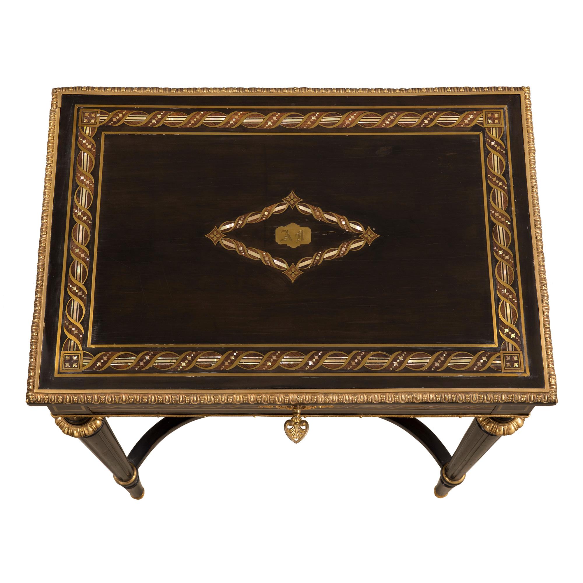 A most elegant and high quality French 19th century Louis XVI style Napoleon III period ebony, brass, tortoiseshell, mother of pearl and ormolu dressing table. The table is raised by fine straight fluted tapered legs with ormolu sabots. The legs are