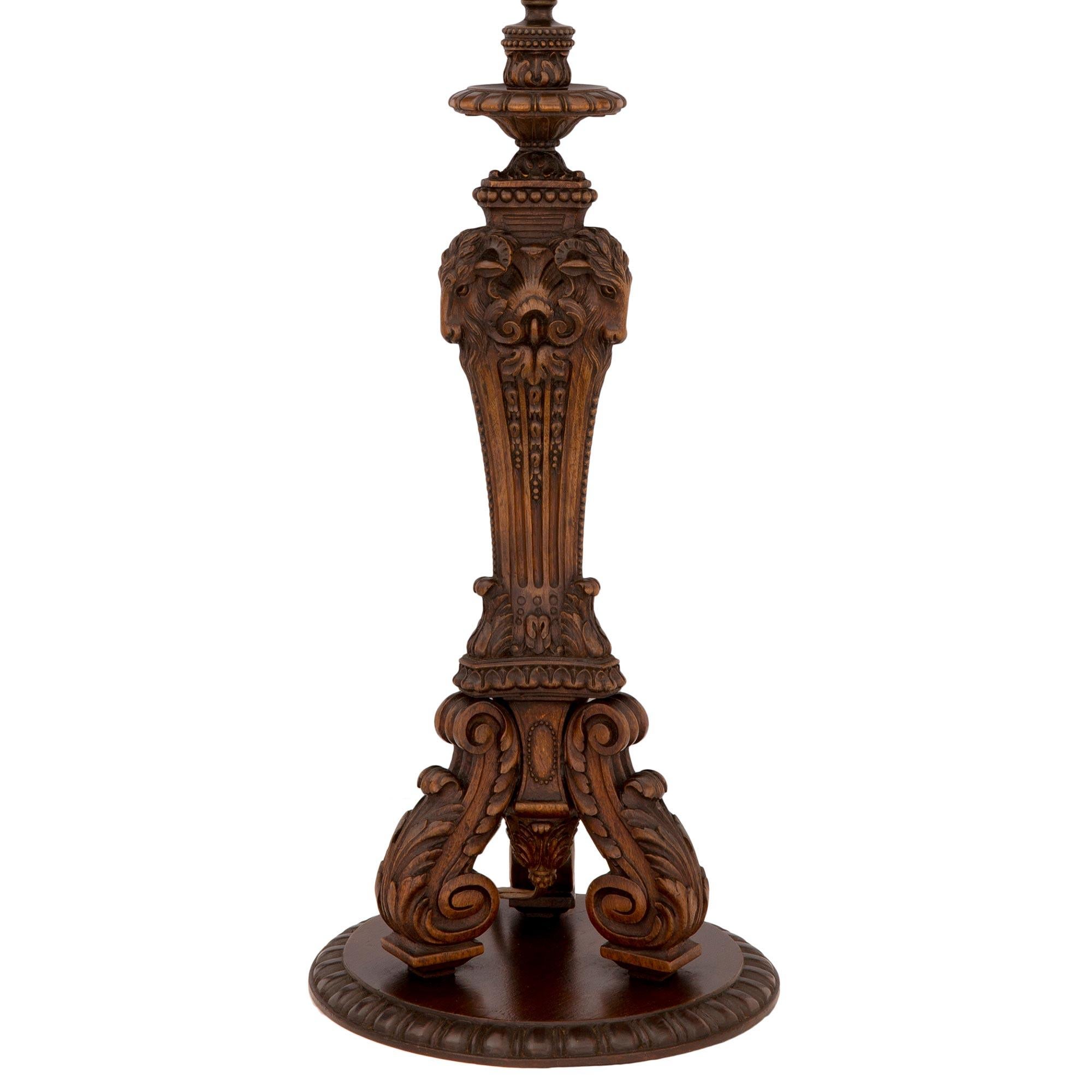 A most elegant French 19th century Louis XVI st. oak lamp. The lamp is raised by a circular base decorated with a fine reeded pattern. Three richly carved scrolled acanthus leaf supports lead up to the triangular shaped central fut. The central fut