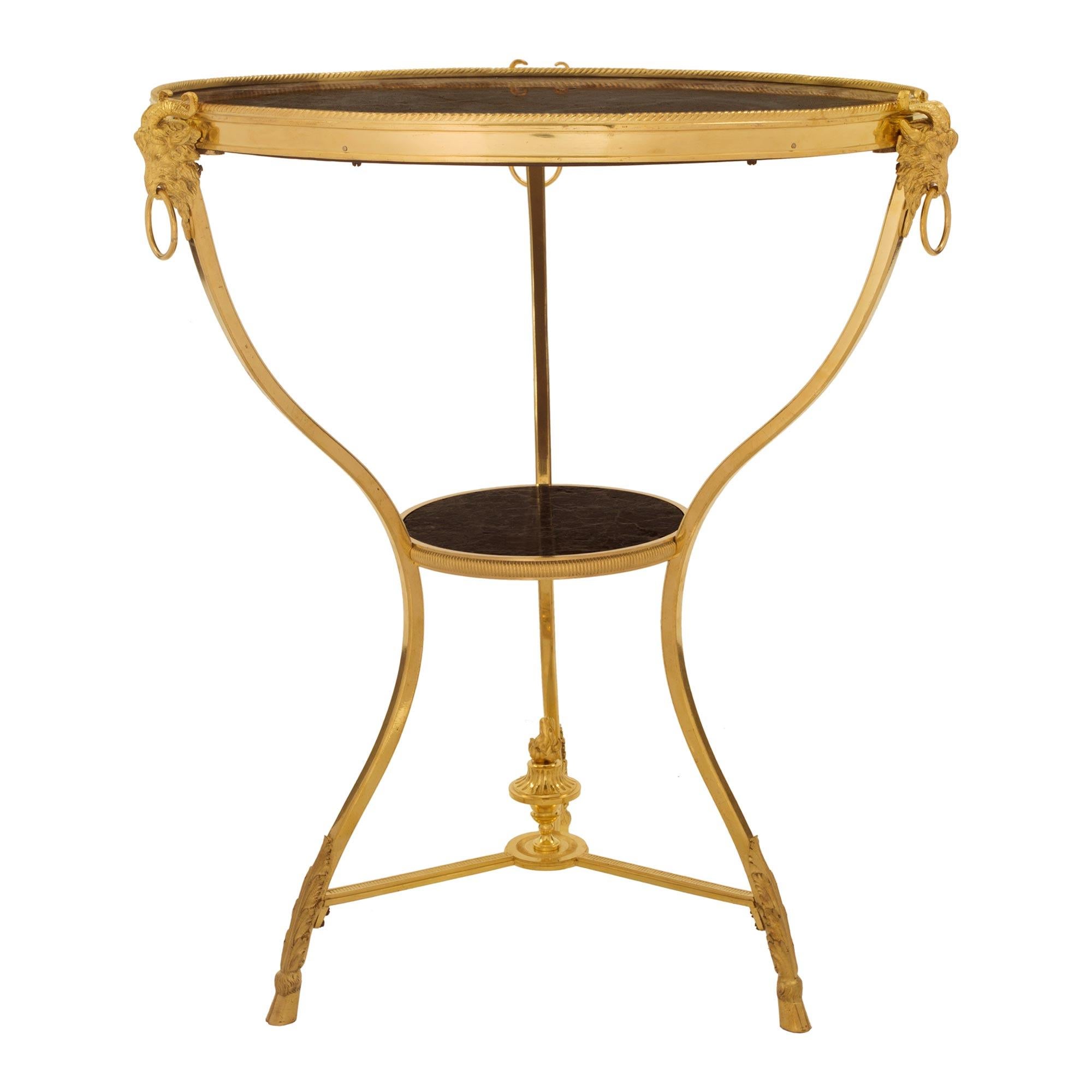 An elegant French 19th century Louis XVI st. ormolu and Vert de Patricia marble Guéridon side table. The table is raised by fine hoof feet below richly chased acanthus leaves in a fine satin and burnished finish. The slender S scrolled legs display