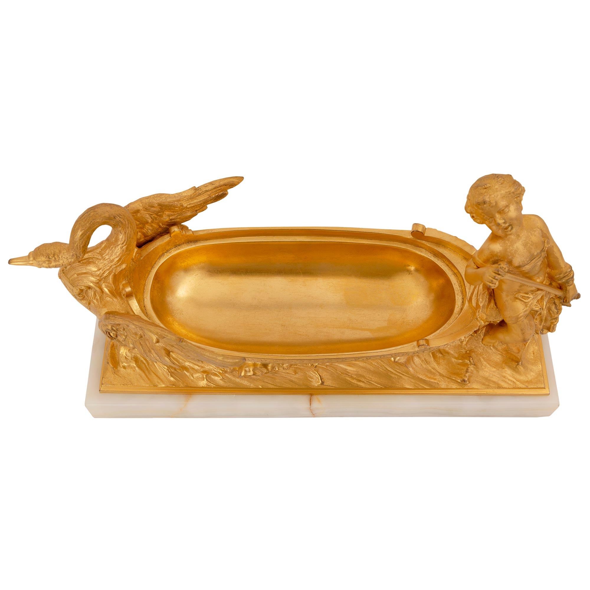 An elegant and high quality French 19th century Louis XVI st. ormolu and onyx cache pot/desk organizer/centerpiece. The centerpiece is raised its original rectangular onyx base showcasing the beautiful marble veins. Above is a most charming and