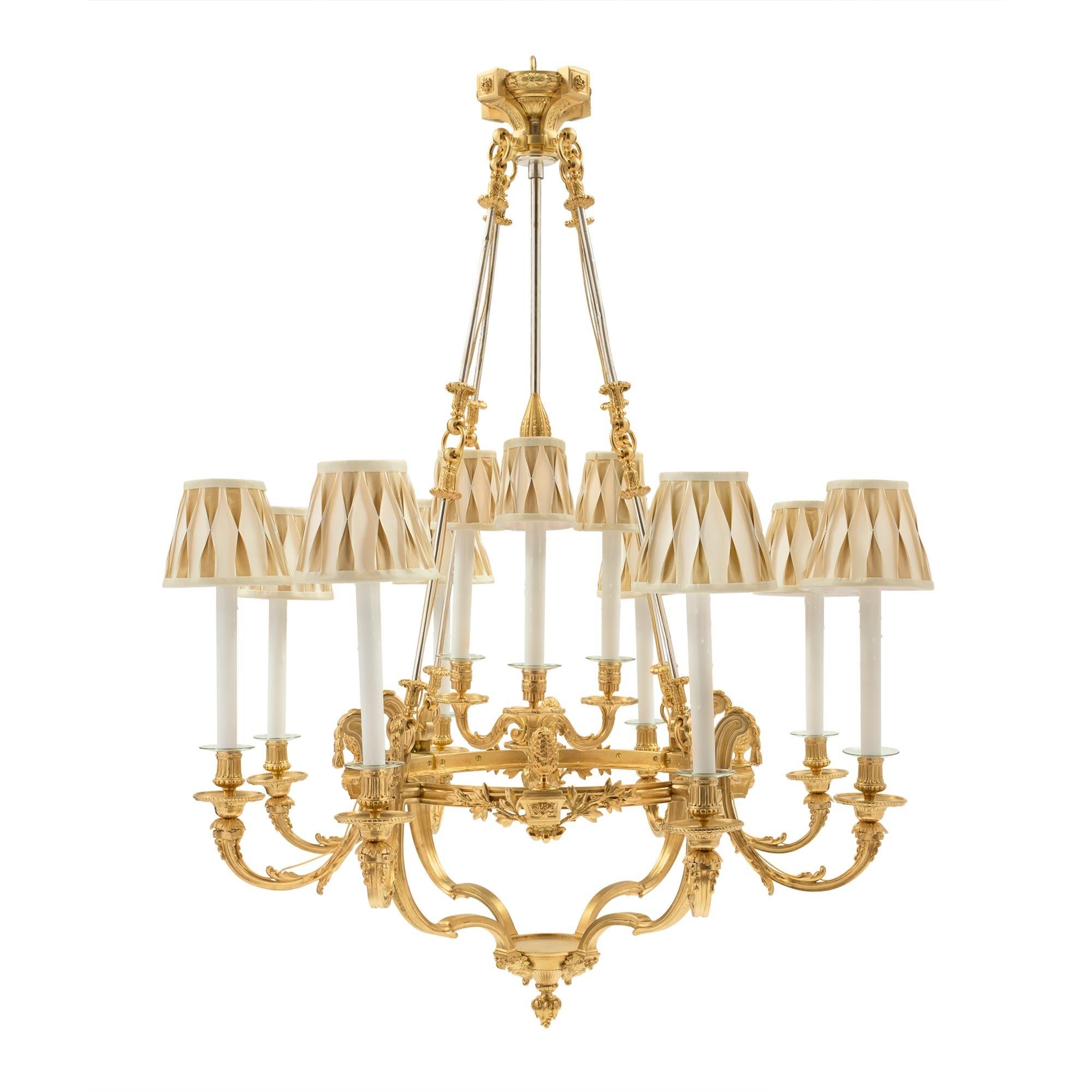An elegant and high quality French 19th century Louis XVI st. ormolu and silvered bronze eight arm chandelier. The chandelier is centered by a finely chased bottom acorn finial joined by four 'S' scrolled arms. Below the arms are wonderful and