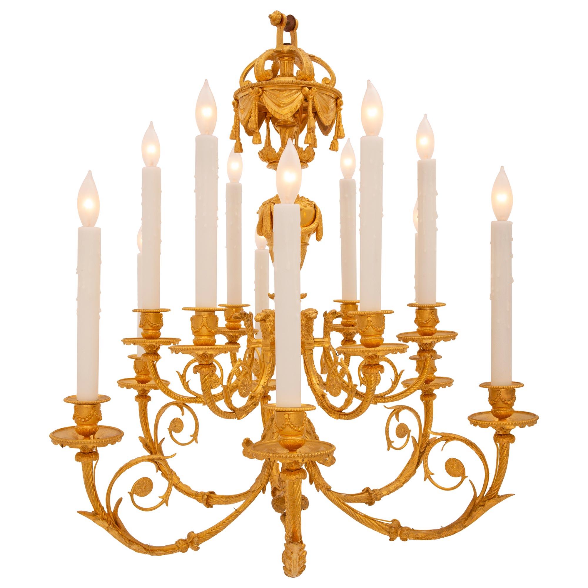 An elegant and extremely high quality French 19th century Louis XVI st. ormolu chandelier. The twelve arm chandelier is centered by a lovely bottom foliate finial below the central fut adorned with richly chased acanthus leaves. The arms are
