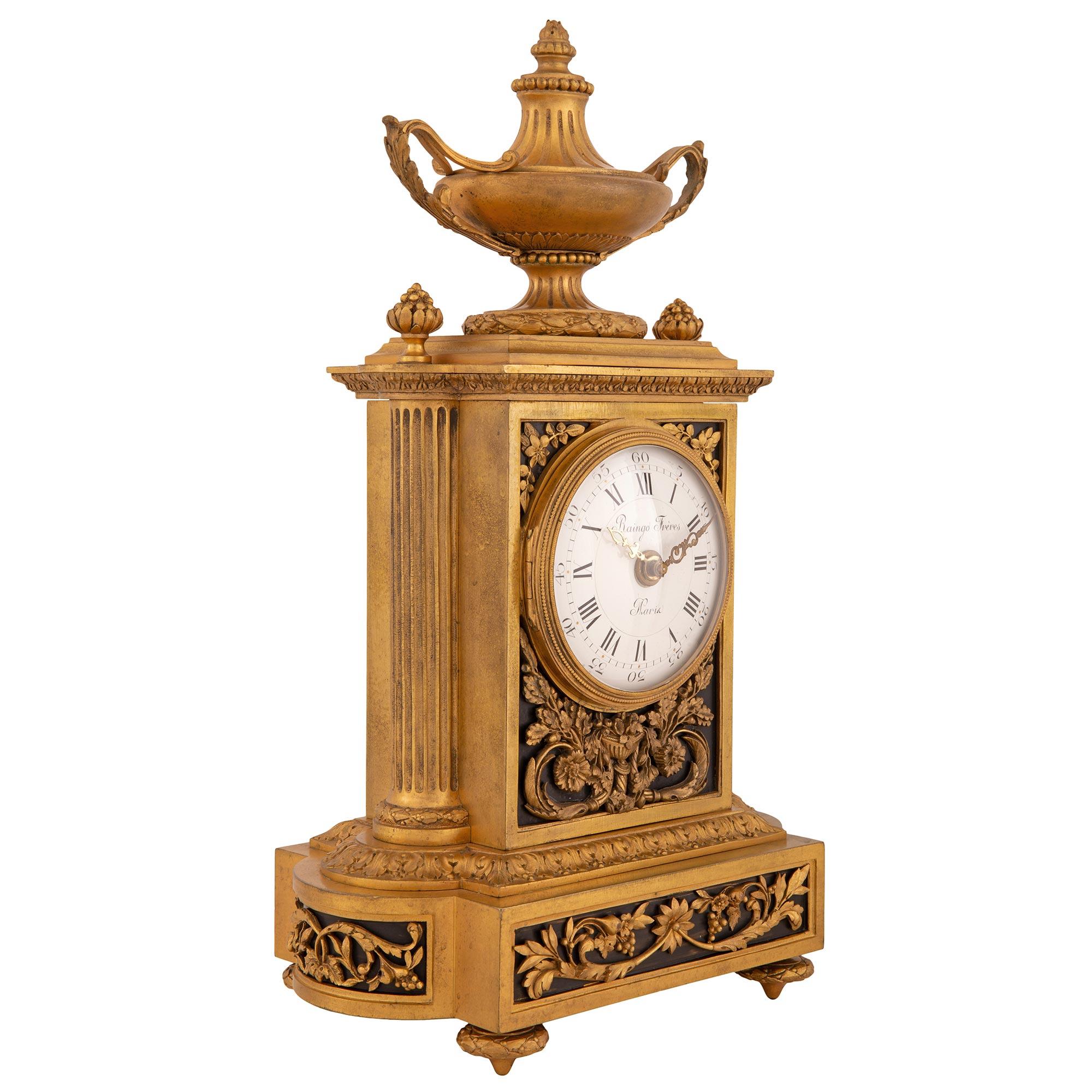 An exceptional and very high quality French 19th century Louis XVI st. ormolu and patinated bronze clock, signed Raingo Frères Paris. The clock is raised by most elegant topie shaped feet with fine berried laurel bands. The base displays exceptional