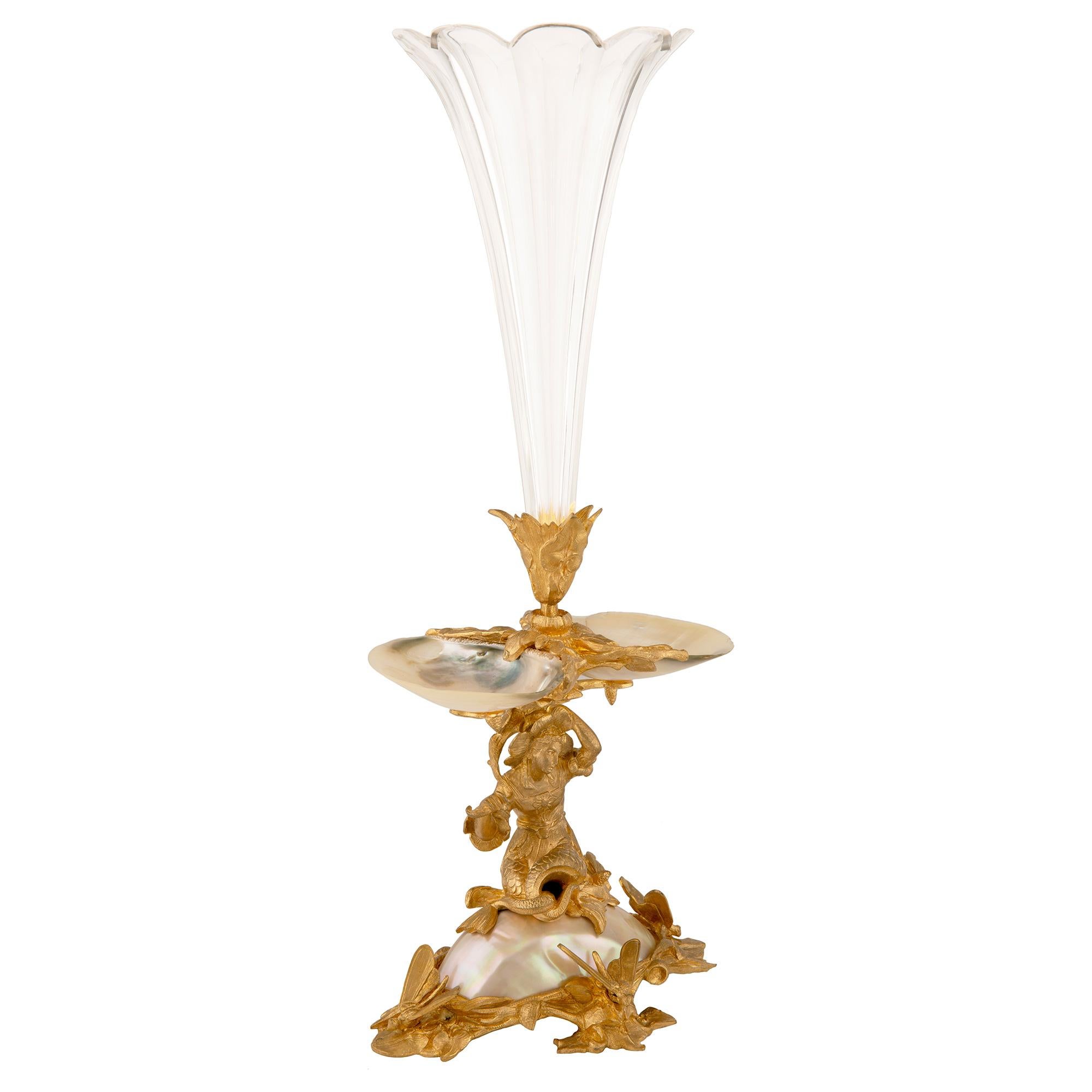 A beautiful French 19th century Louis XVI st. ormolu, Baccarat crystal and mother of pearl vase. The vase is raised by a most impressive and wonderfully executed base with beautiful rock and foliate designs, charming dragon flies and a most