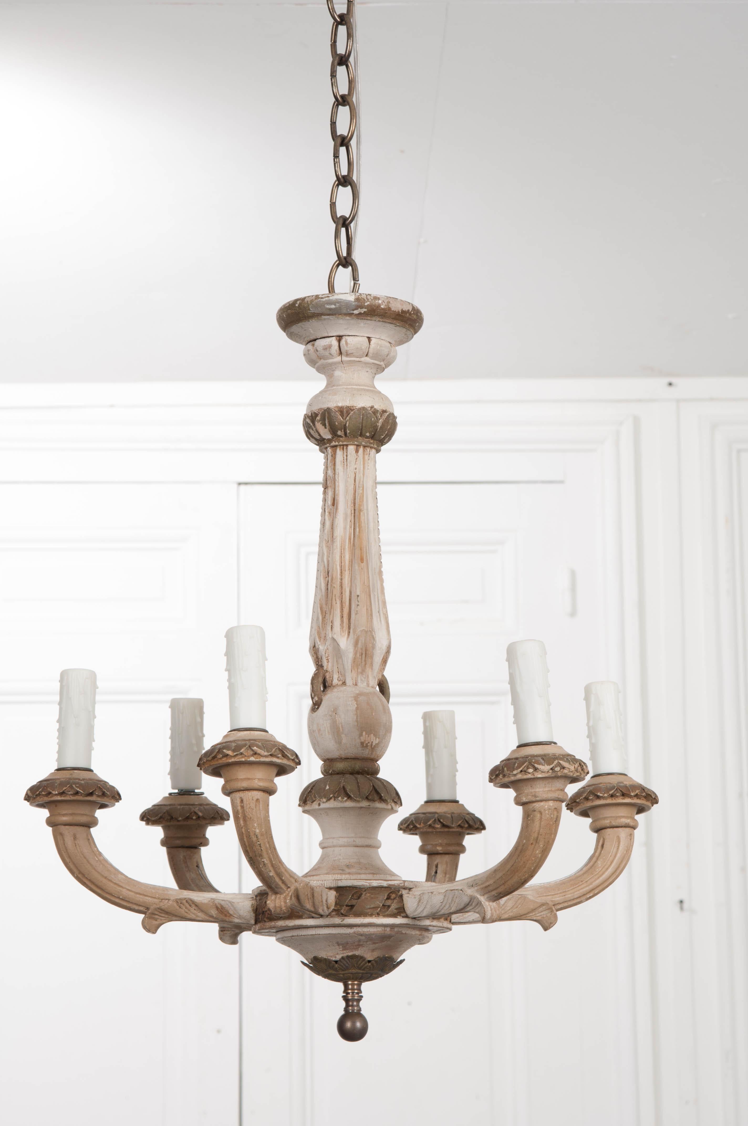 This attractive Louis XVI-style painted and parcel-gilt six-arm chandelier has a lovely patina and would finish a boudoir or powder room nicely. The fluted standard tapers upward and has upper and lower acanthus leaf-carved collars, with like-carved