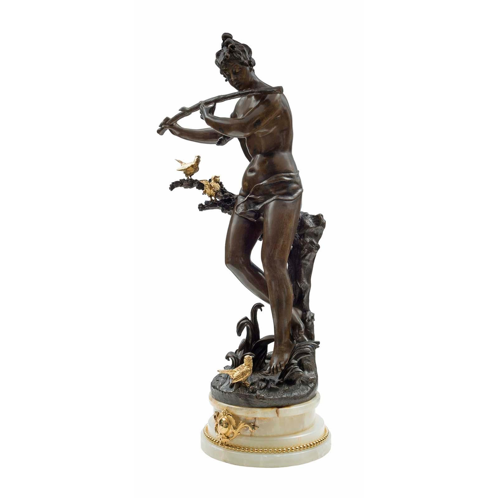 A charming French 19th century Louis XVI style patinated bronze, ormolu and onyx statue, signed Rousseau. The statue is raised by a cream colored onyx mottled base decorated by an ormolu beaded band and a front crest with the engraved title of the