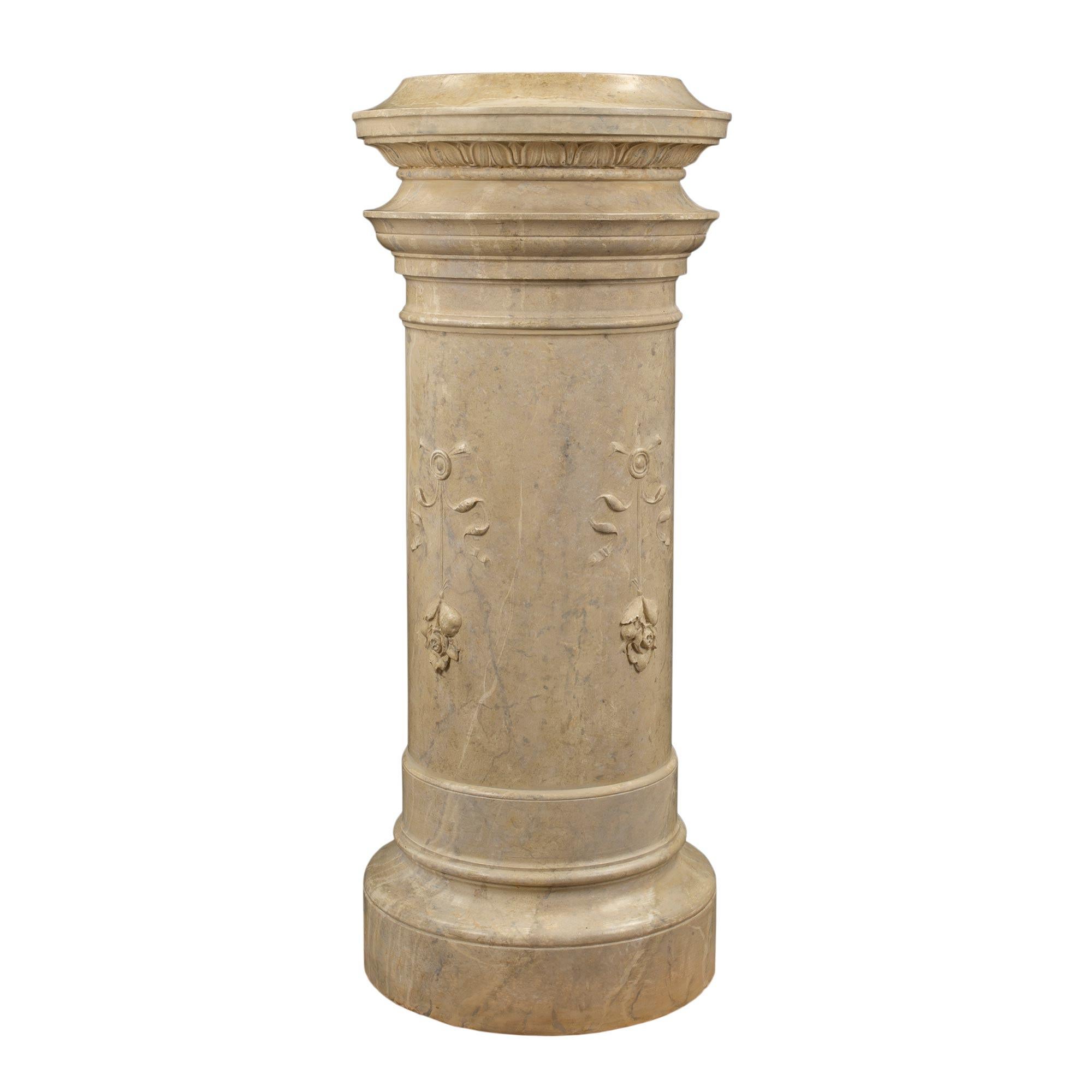A pair of beautiful French 19th Century Louis XVI st. plaster columns with a faux marble finish. Each superb column/pedestal is raised on a circular base with moulded borders. The columns are decorated with stunning bow designs with hanging rosette.