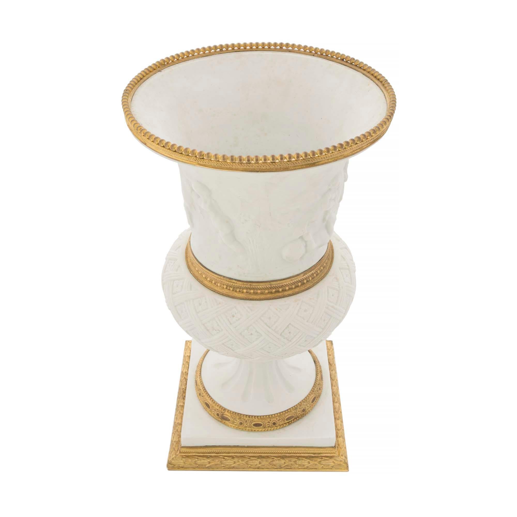 A very handsome French 19th century Louis XVI st. Biscuit de Sèvres porcelain and ormolu Medici designed vase. The vase is raised on a chased ormolu base below a square support and fluted socle adorned with foliate designed ormolu bands. An
