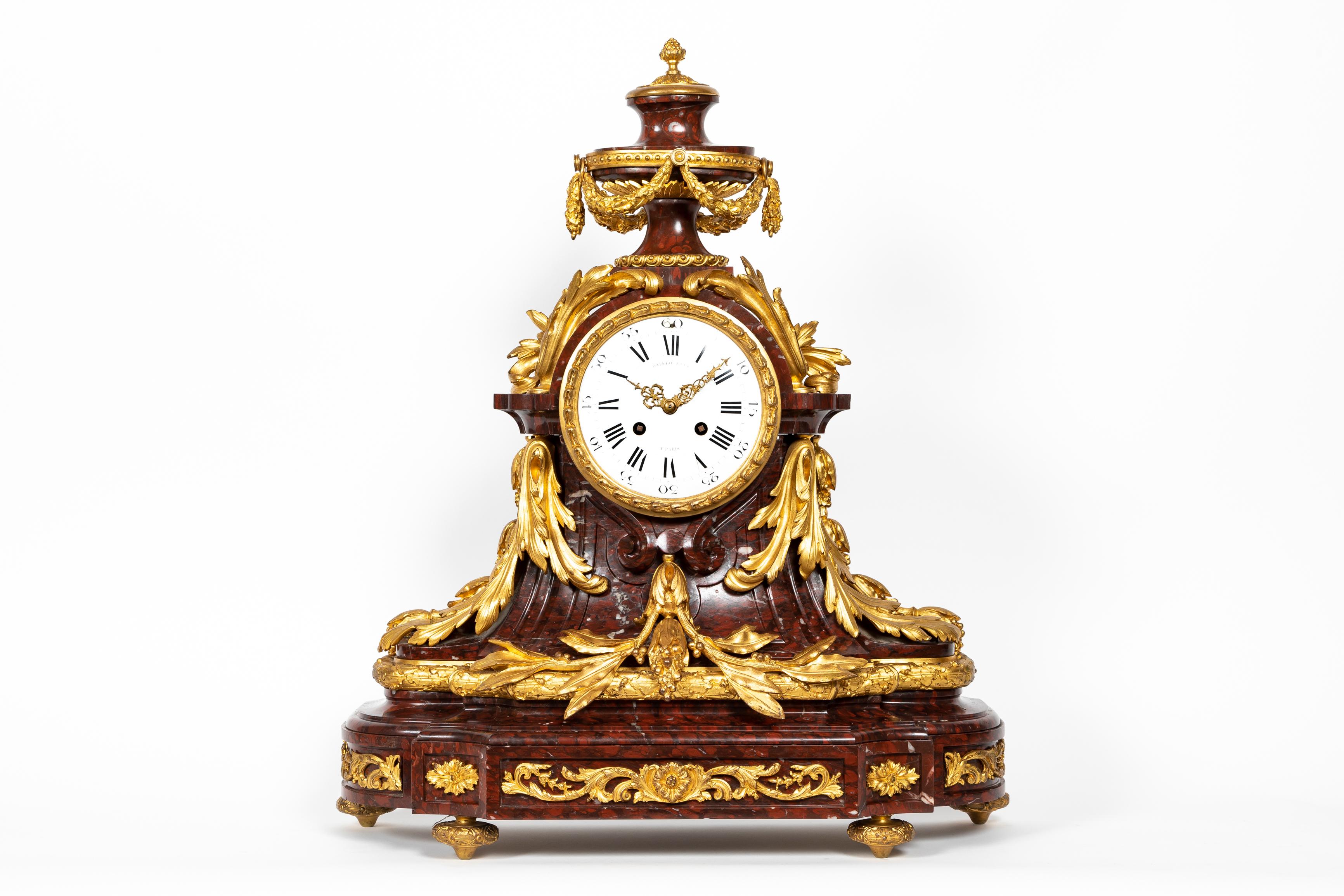 A Magnificent Large Antique French 19th Century Ormolu and Rouge Griotte marble clock set of exquisite craftsmanship. This spectacular clock set is comprising a pair of very large nine arm double tier ormolu bronze and hand carved griotte marble