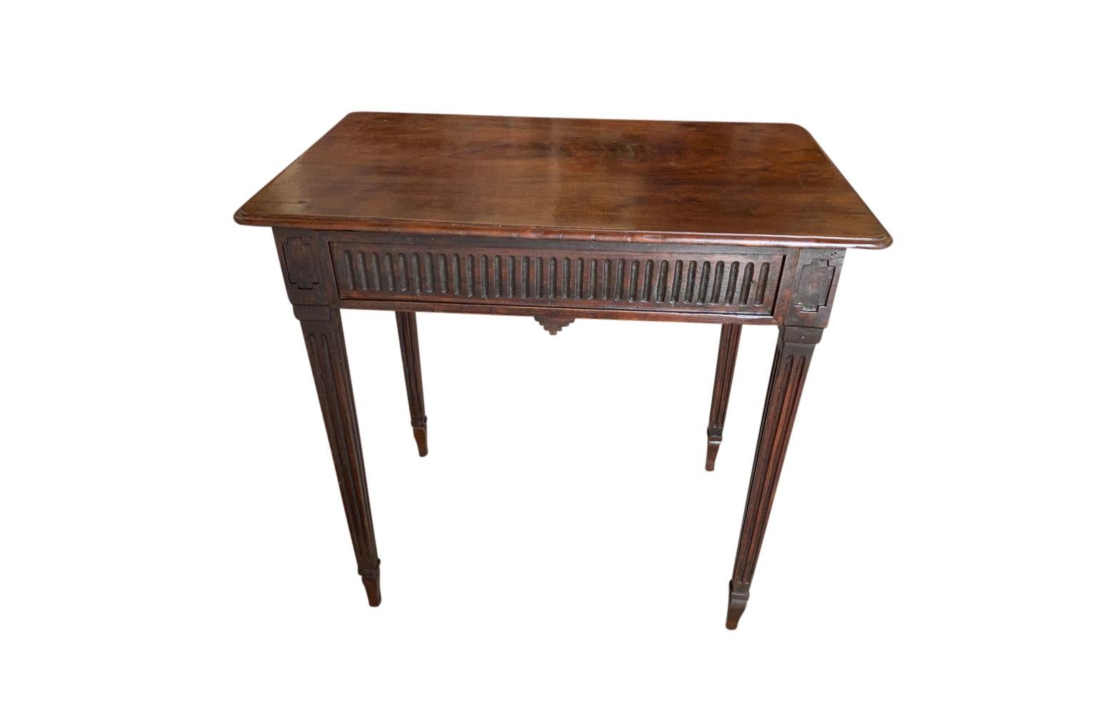 A very handsome later 19th century French Louis XVI style side table soundly constructed from beautiful walnut. Wonderful fluted and tapered legs with a single drawer. Perfect as an occasional table or bedside table.
