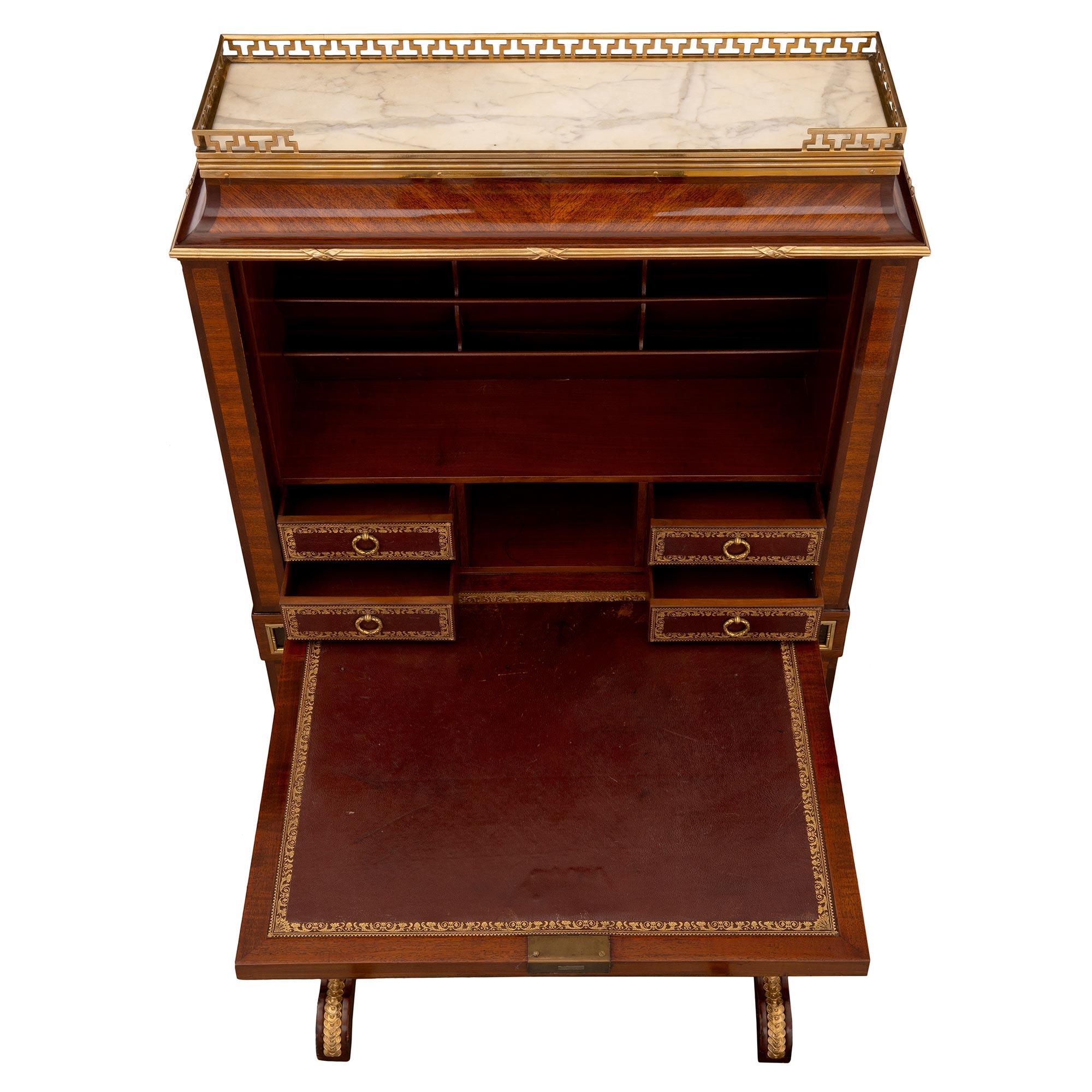 A very handsome and high quality French 19th century Louis XVI St. tulipwood, kingwood and ebony drop front desk. The desk is raised by four square columns joined by a bottom tier and decorated with a pierced ormolu gallery. Above is an exquisite