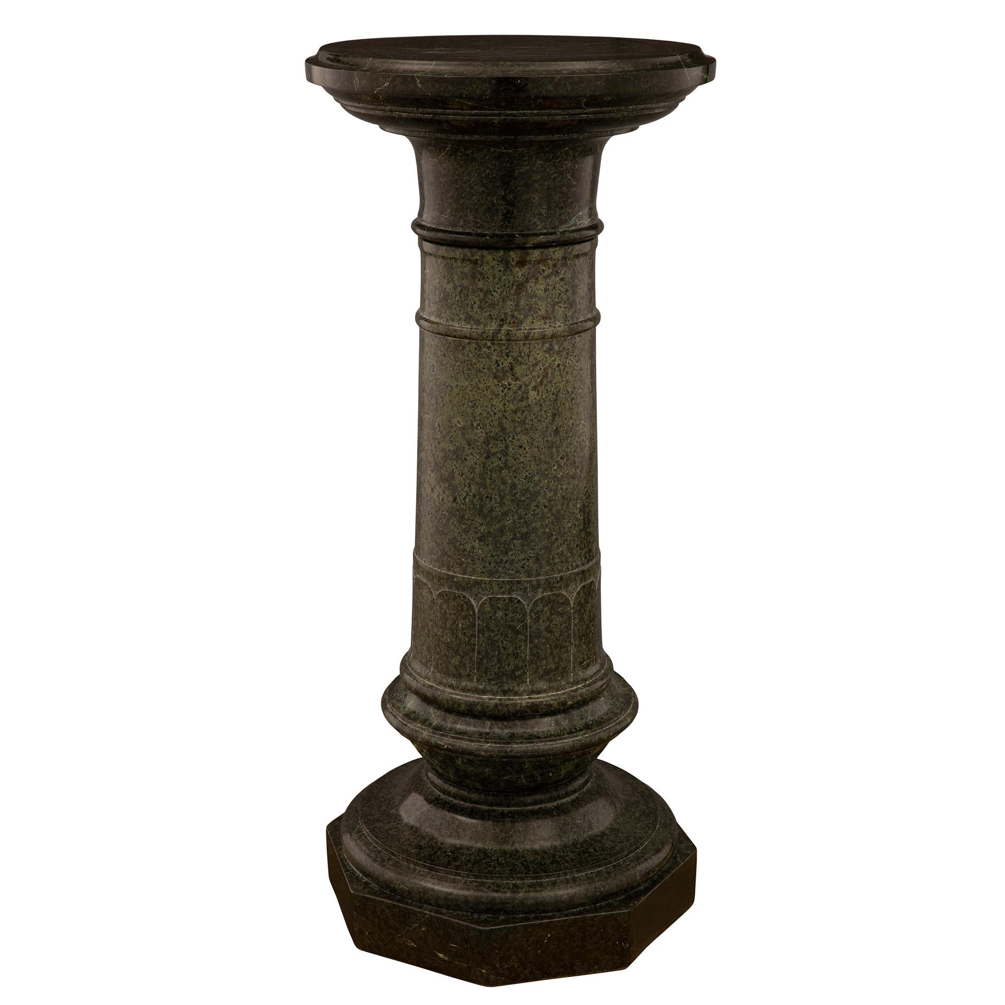 A fine French 19th century Louis XVI St. Vert de Patricia marble pedestal column. The pedestal is raised by an octagonal base below a socle pedestal with an elegant mottled border. The lightly tapered central support displays a sculpted arched