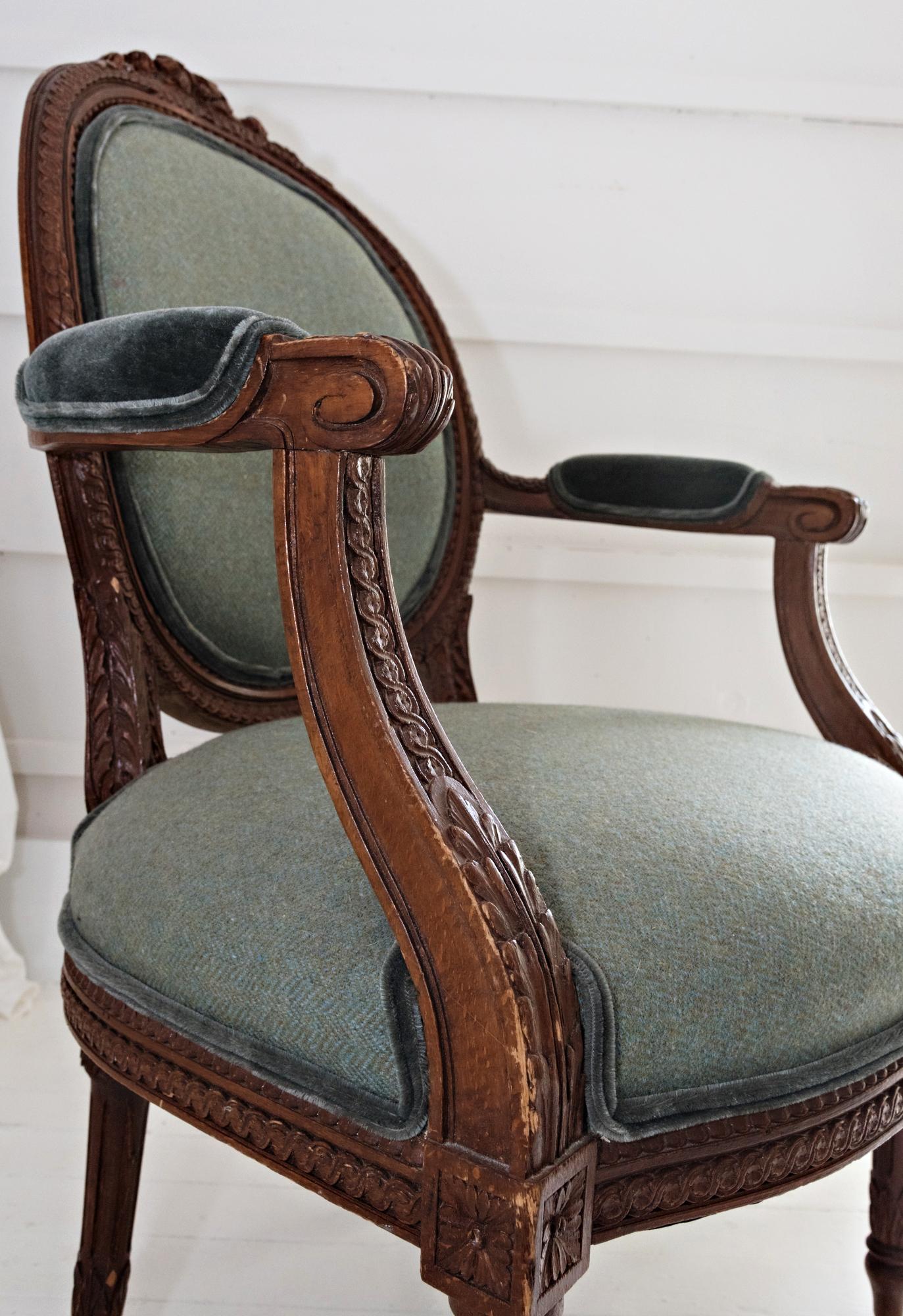 Gorgeous carved walnut Louis XVI fauteuil covered in Ralph Lauren teal tweed with contrasting teal mohair. The Louis XVI style having an oval padded
back surmounted by a carved bow motif, joined by padded outscrolled arms
to the padded seat,