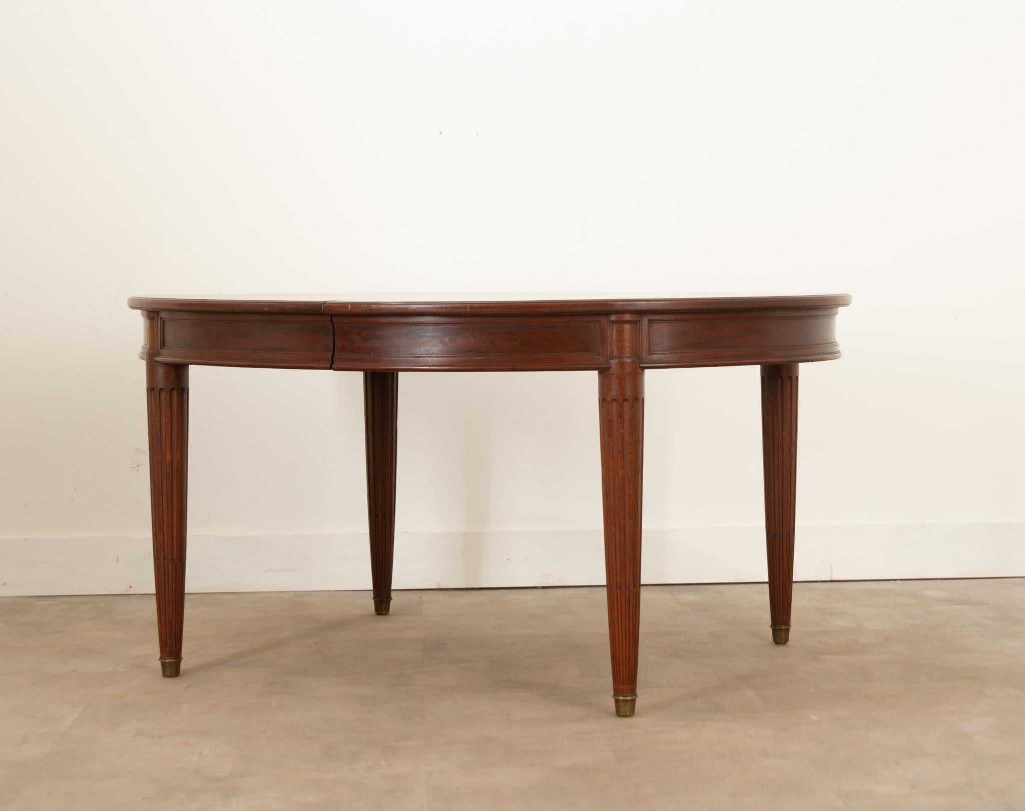 A great Louis XVI style extending dining room table from 19th century France crafted from beautifully aged mahogany. Three unfinished leaves are included and bring the table to 117-?” wide. The leaves are supported by a pair of hidden legs that