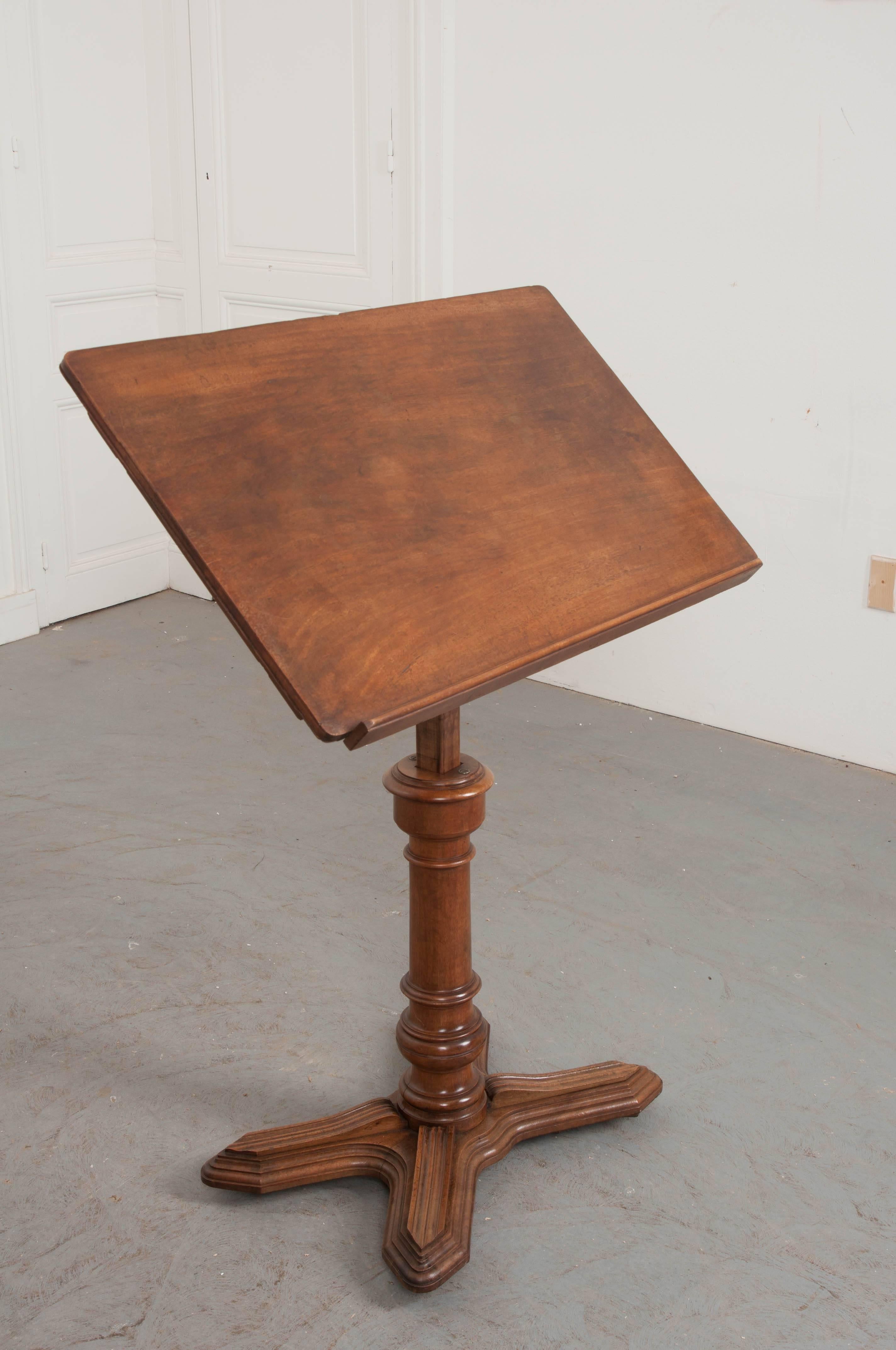 A dapper, stately mahogany podium or lectern from 19th century France. This fully-adjustable stand has been constructed using beautiful solid mahogany. The large top surface measures 20 1/4? H x 35? W. Its pitch can be adjusted to suit the users’