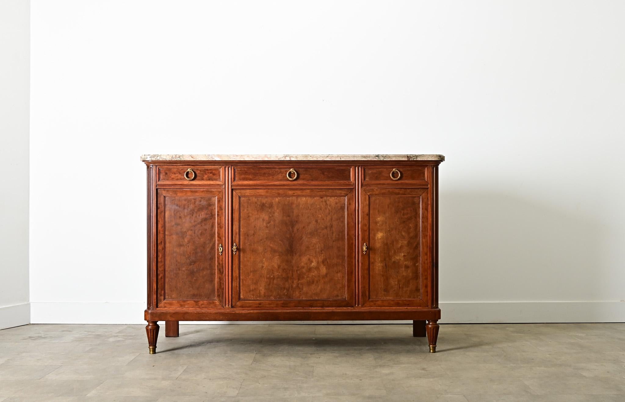 A unique, 19th century Louis XVI style mahogany enfilade attributed to Haentges Freres, Paris, in a variety of gorgeous materials to enchant in a dining room or other living space with color and patina. The top surface of brecciated marble features