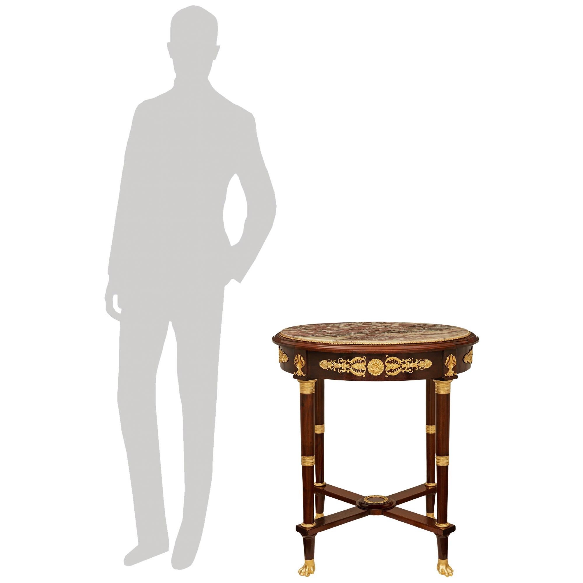 A striking and high quality French 19th century Mahogany, Ormolu and Breche Violette marble side table. This impressive table is raised on circular tapered legs supported on Ormolu pawed feet below a handsome stretcher centered by a circular foliate
