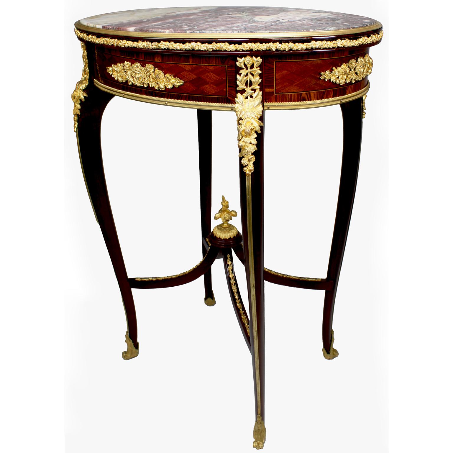 A very fine French 19th-early 20th century Louis XV style mahogany, tulipwood, parquetry and ormolu mounted oval gueridon side table with a Brêche Violette marble top, attributed to François Linke (1855-1946). The inset oval Brêche Violette marble