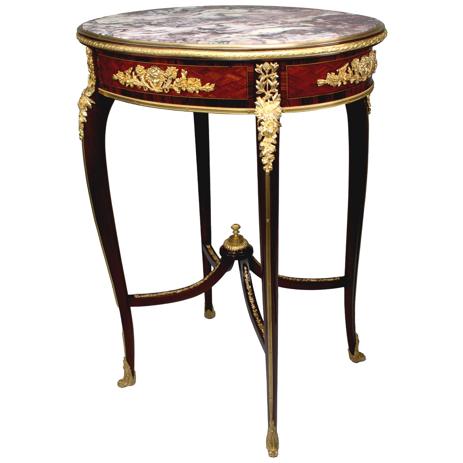 A very fine French 19th-early 20th century Louis XV style mahogany, tulipwood, parquetry and ormolu mounted oval gueridon side table with a Brêche Violette marble top, attributed to François Linke (1855-1946). The inset oval Brêche Violette marble